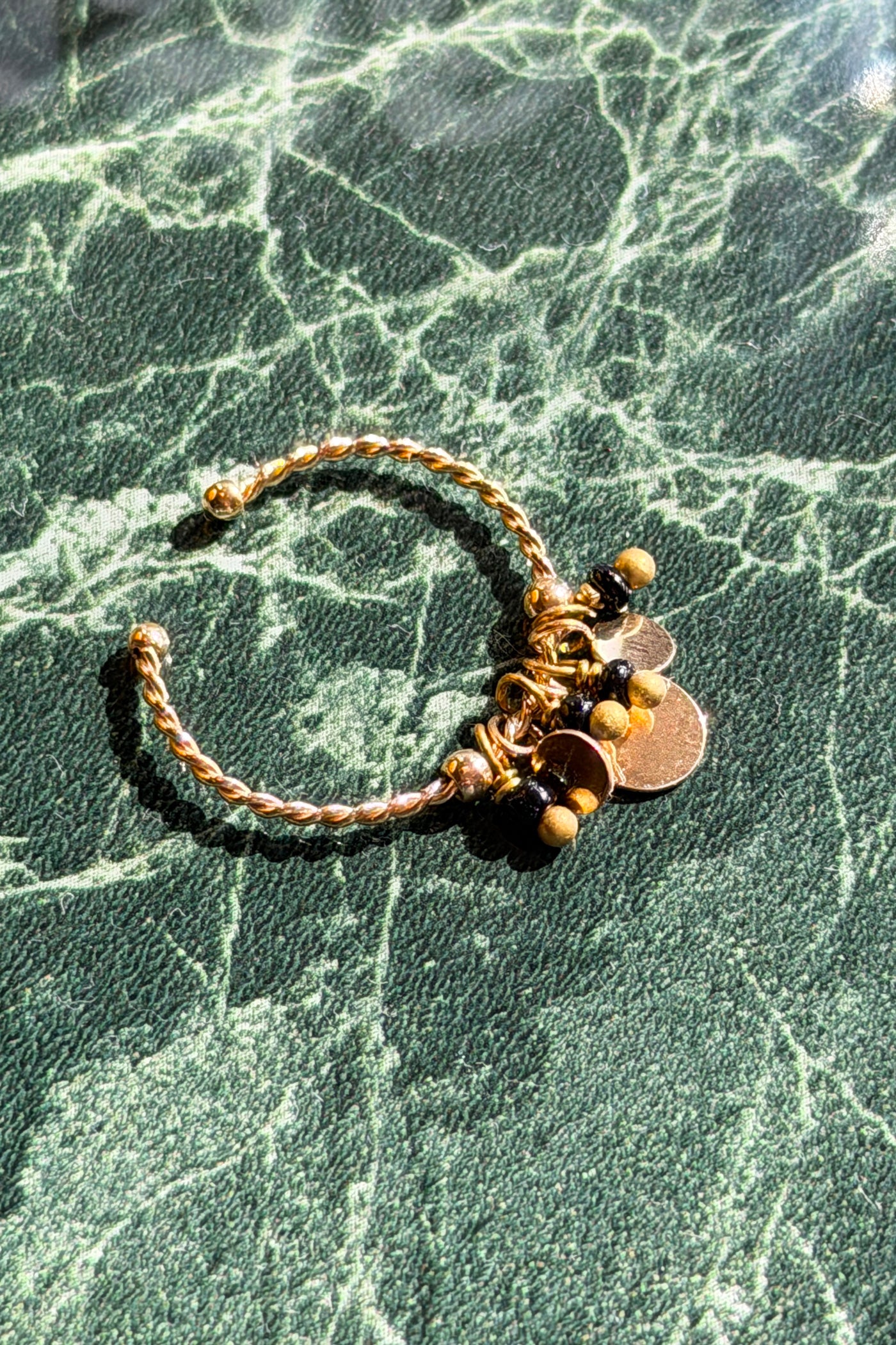 Adjustable gold braided ring with small black charms