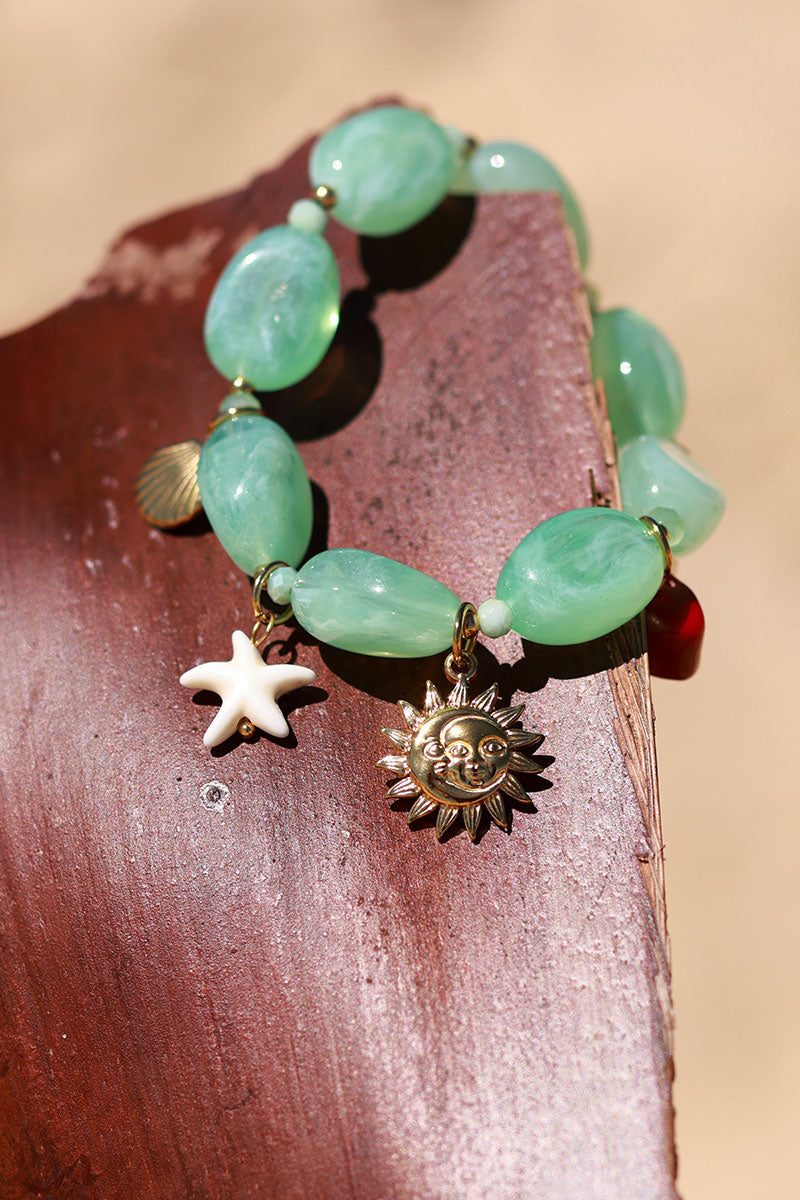 Bracelet élastique en perles résines turquoise style pierres breloques plage