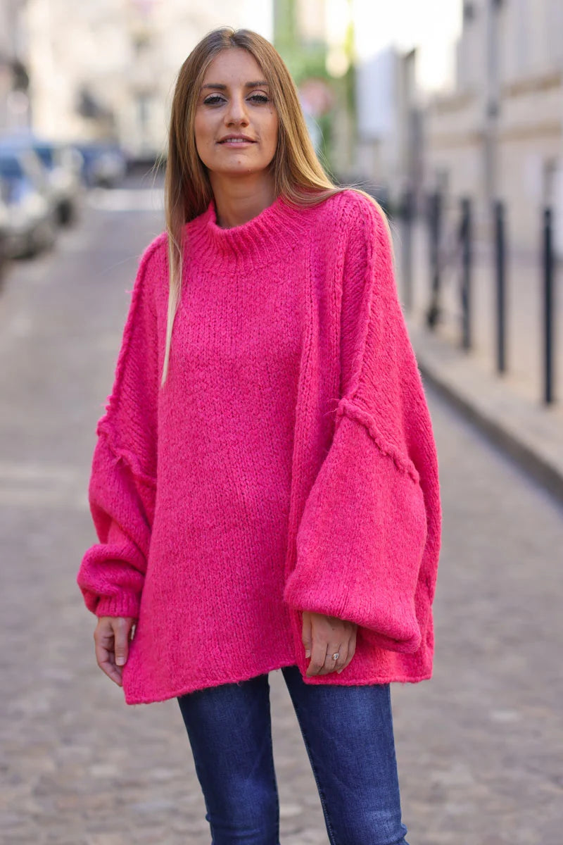 Gros pull large fuchsia en maille chaude couture apparente