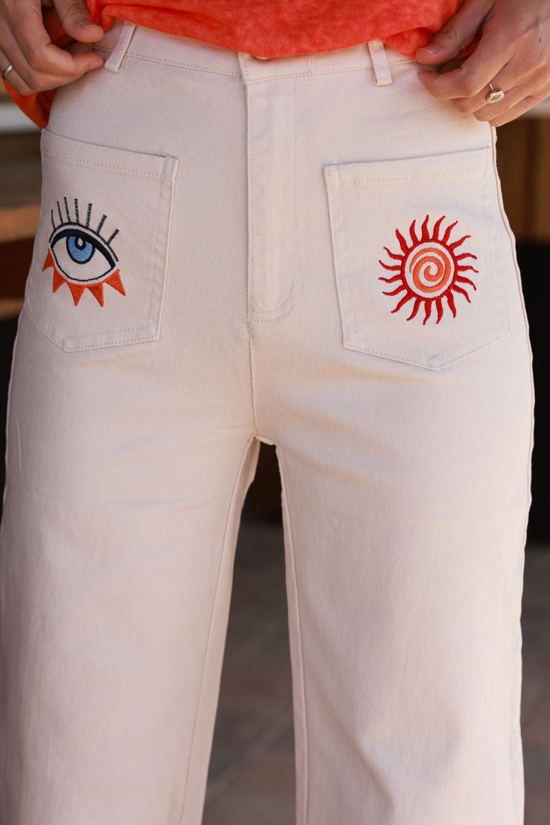 Jean beige coupe droite wide taille haute poches broderie soleil et œil