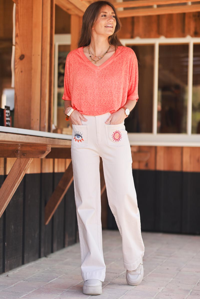Jean beige coupe droite wide taille haute poches broderie soleil et œil