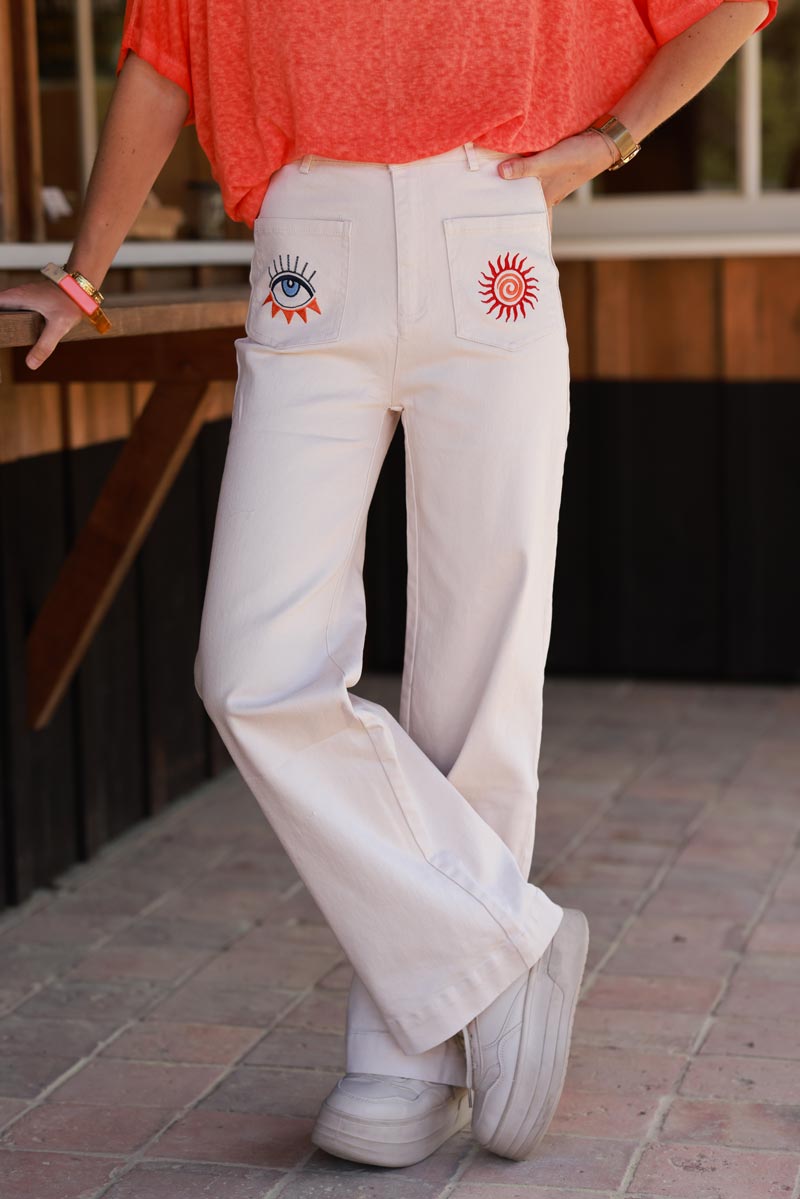 Jean beige coupe droite wide taille haute poches broderie soleil et œil