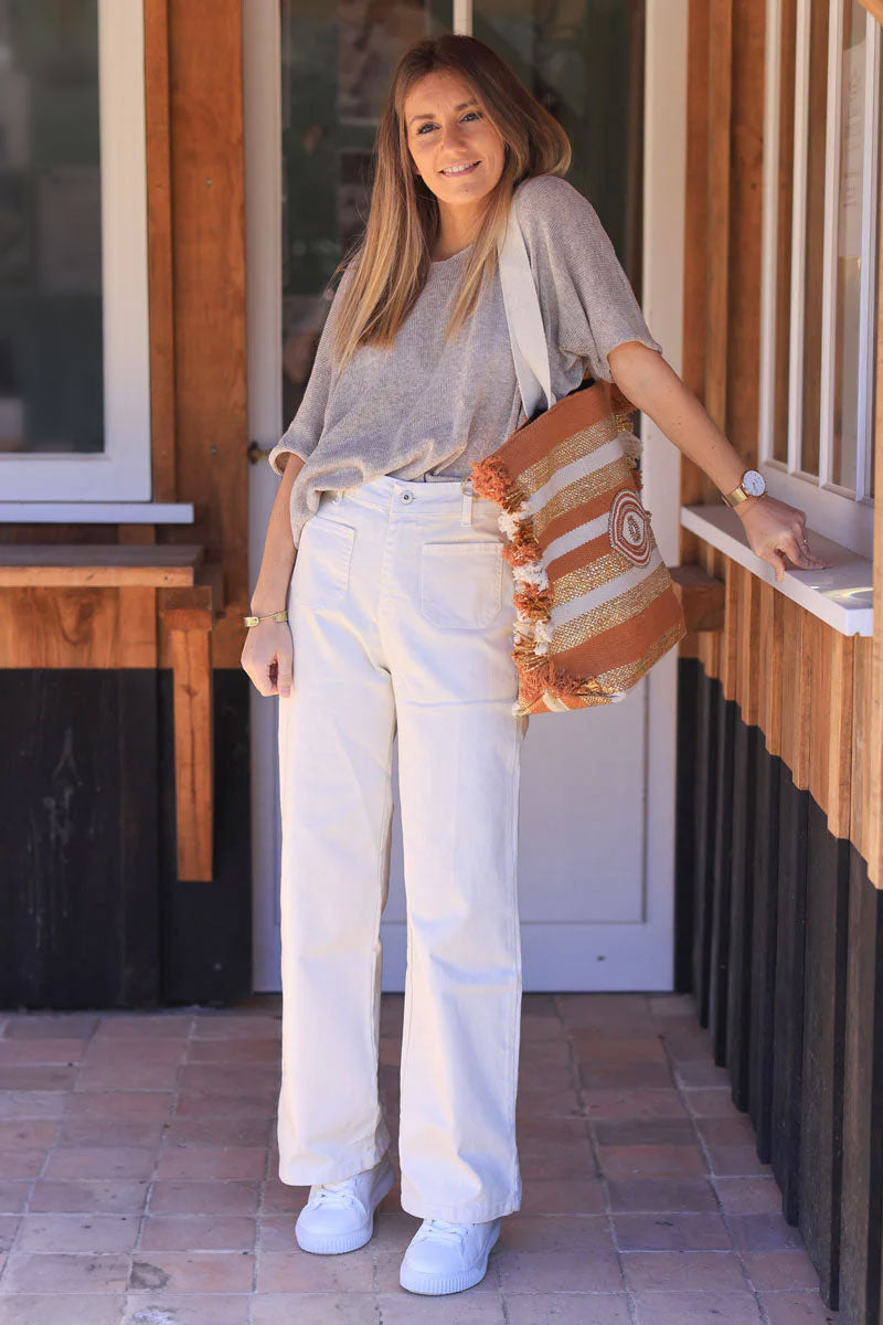 Off white bootcut jeans with a wide leg cut and patch pockets