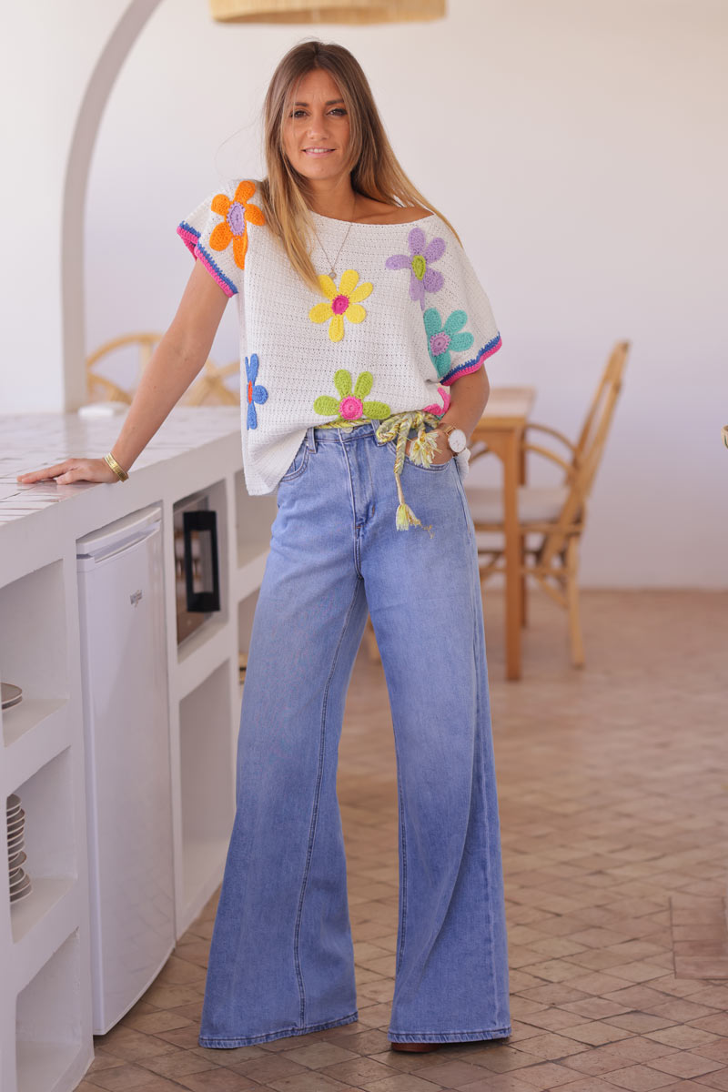 Light washed denim flare jeans with woven colourful and gold belt