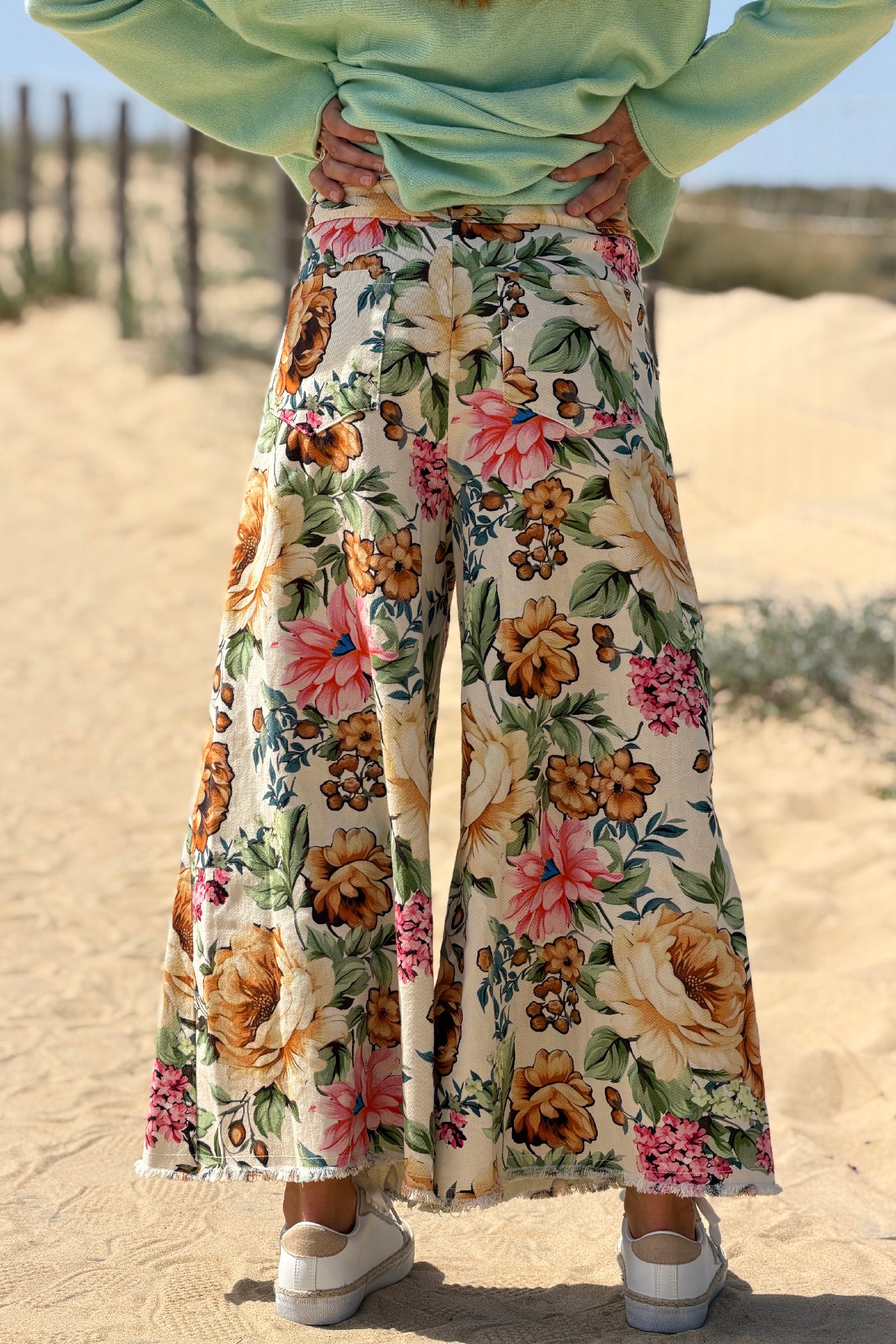 Jean large wide leg beige avec finitions petites franges et motif fleurs colorées