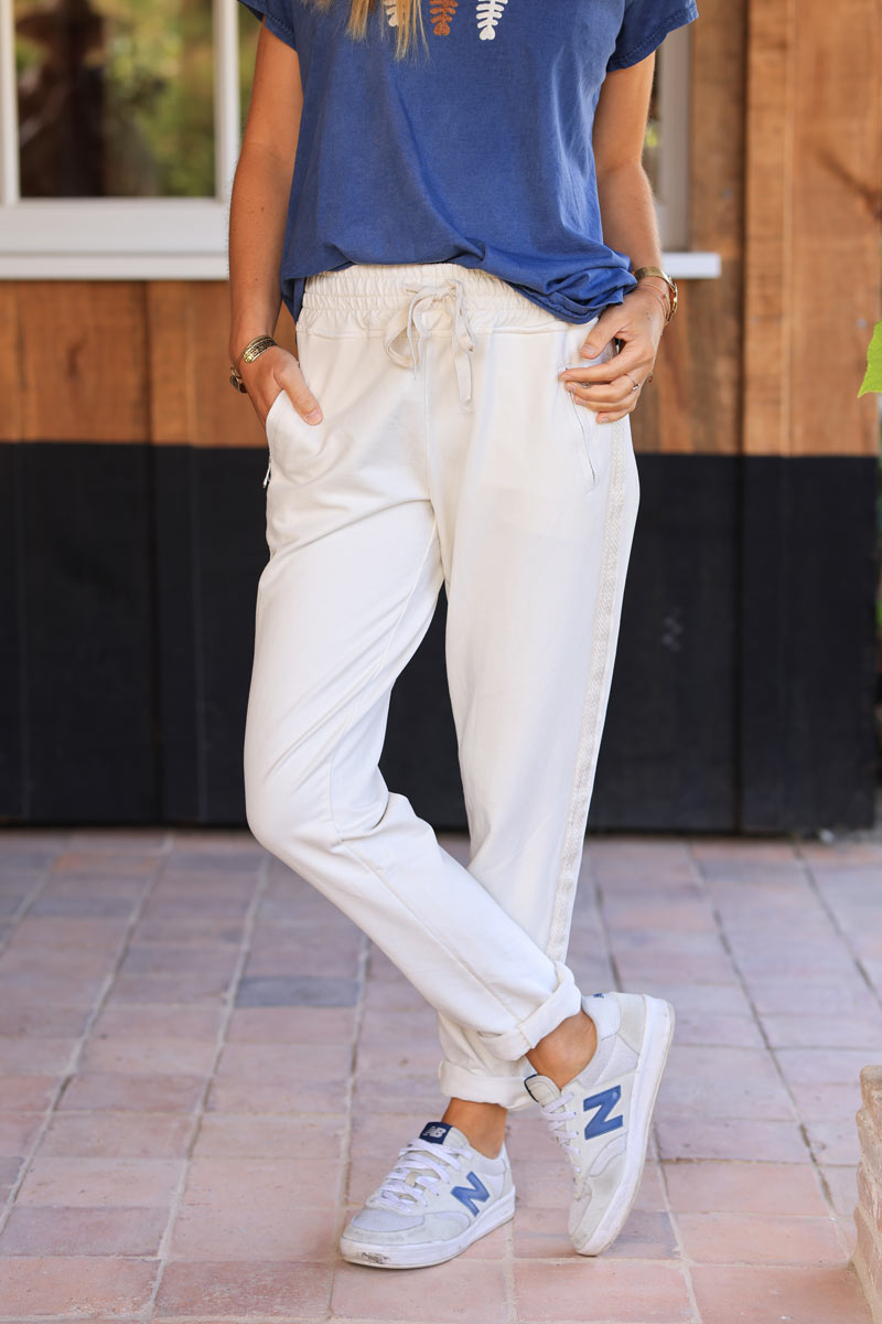 Ecru cotton jogging bottoms with embroidered cheveron outseams