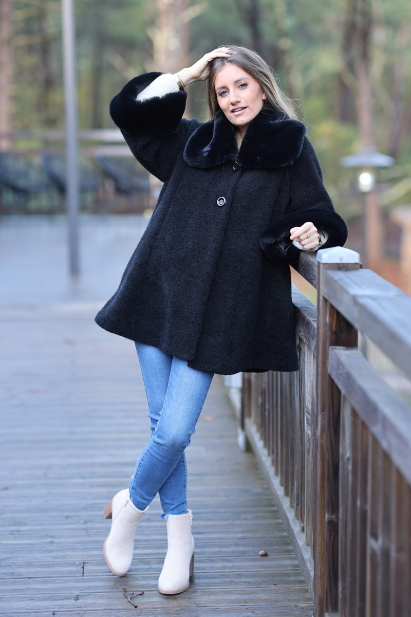 Poncho cape coat in black soft knit with faux fur collar and cuffs