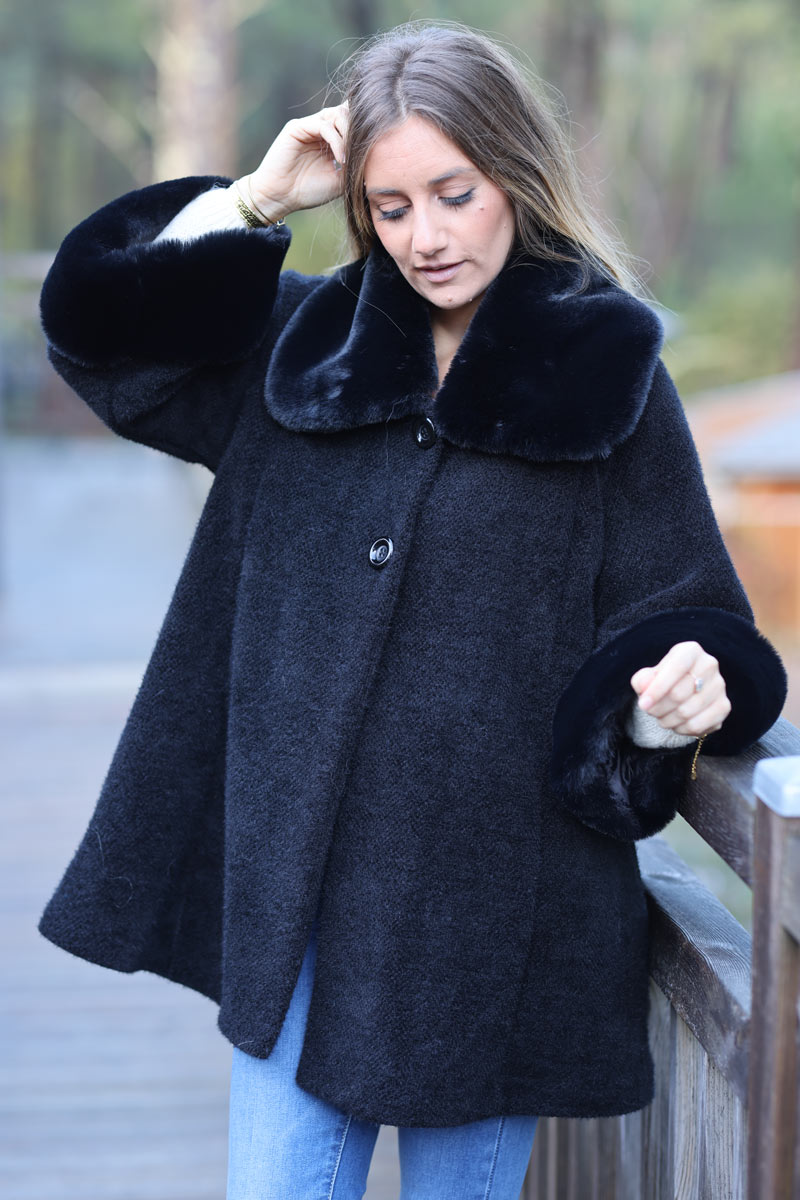 Poncho cape coat in black soft knit with faux fur collar and cuffs
