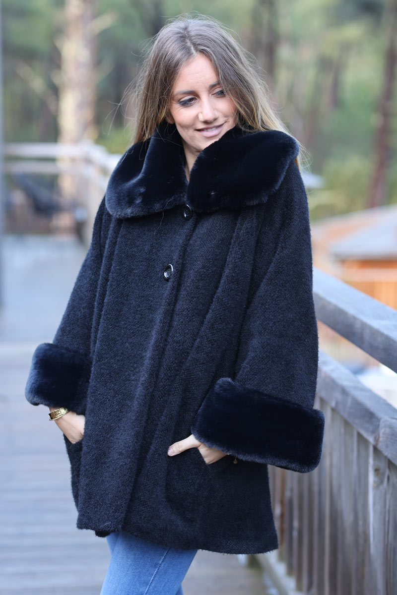 Poncho cape coat in black soft knit with faux fur collar and cuffs