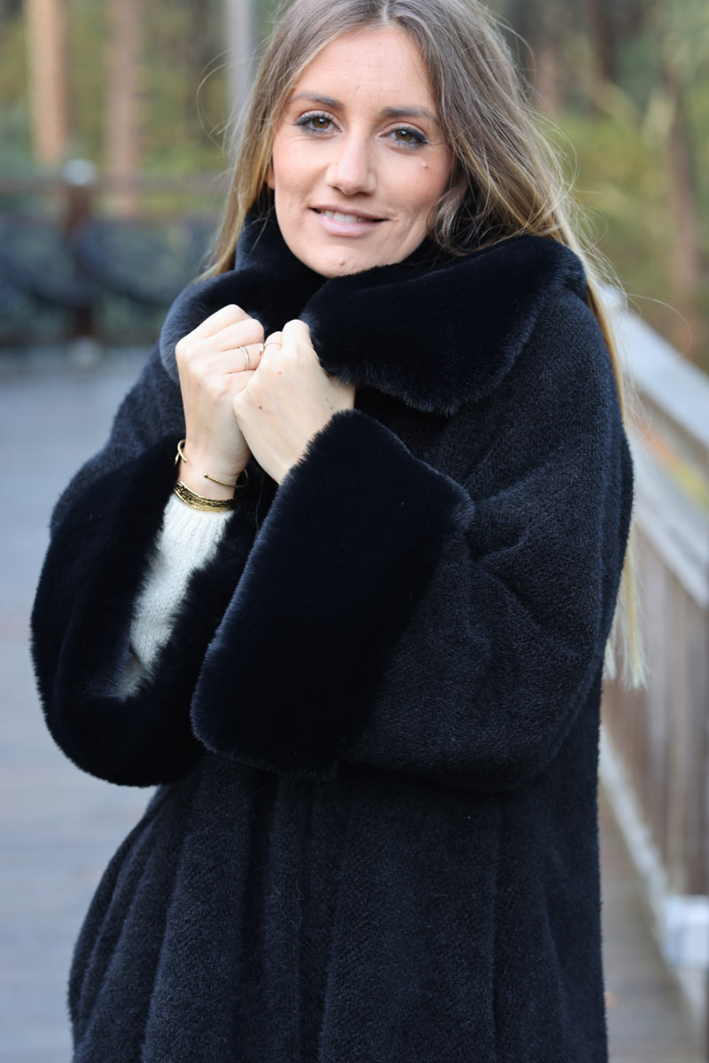 Poncho cape coat in black soft knit with faux fur collar and cuffs