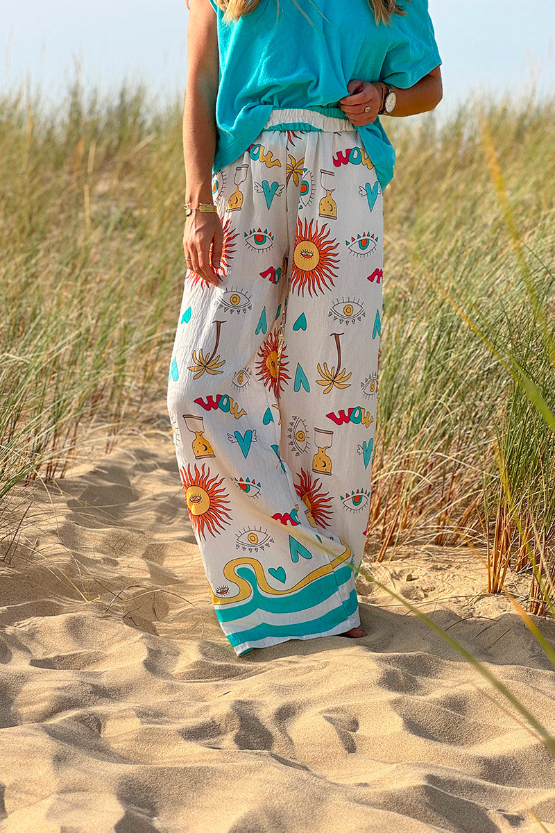 Pantalon fluide écru symboles soleil œil et cœurs colorés turquoise