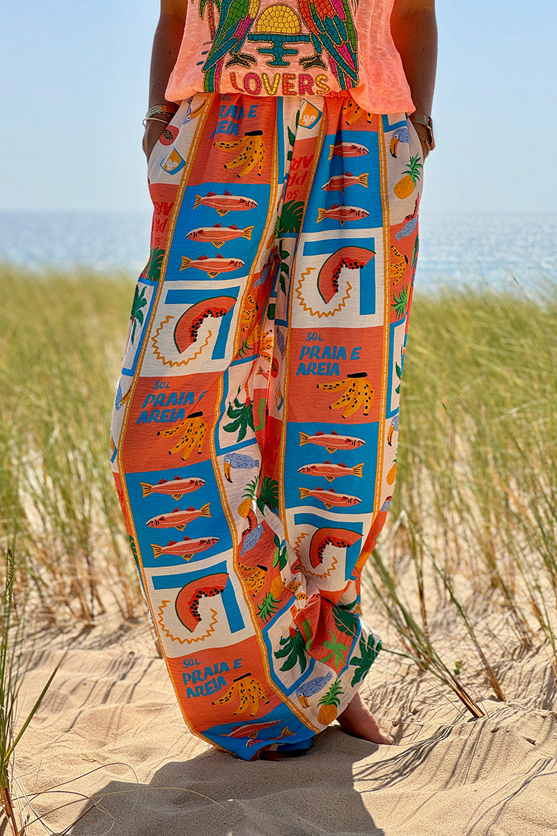 Pantalon fluide imprimé vacances d'été pastèques ananas et palmiers colorés