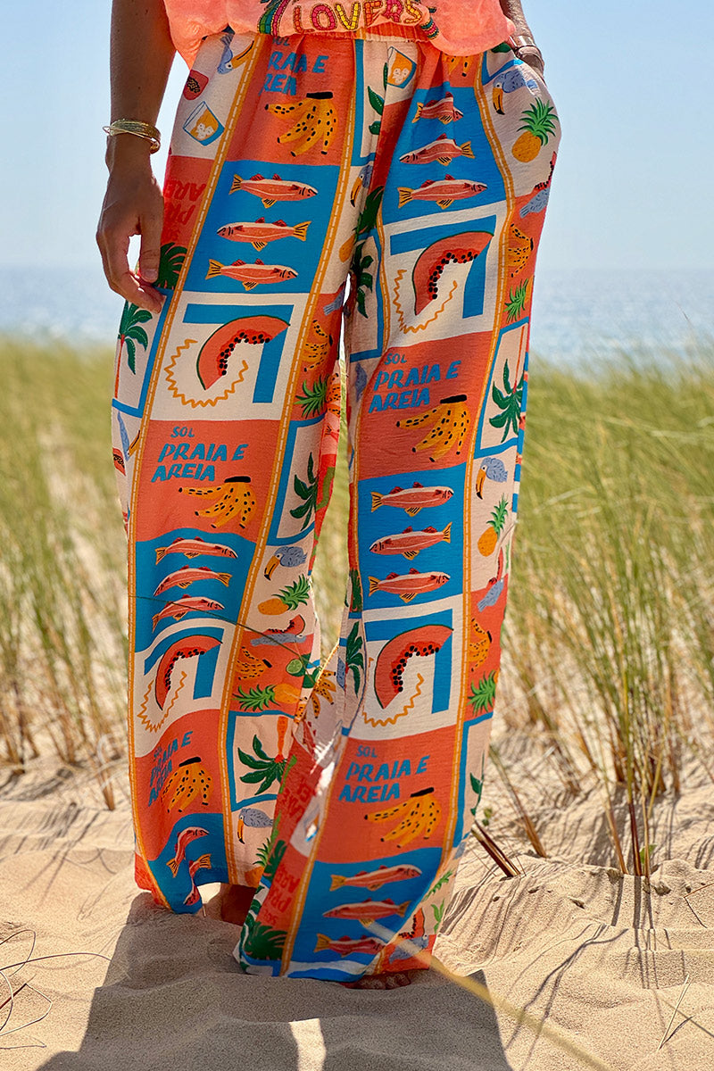 Pantalon fluide imprimé vacances d'été pastèques ananas et palmiers colorés