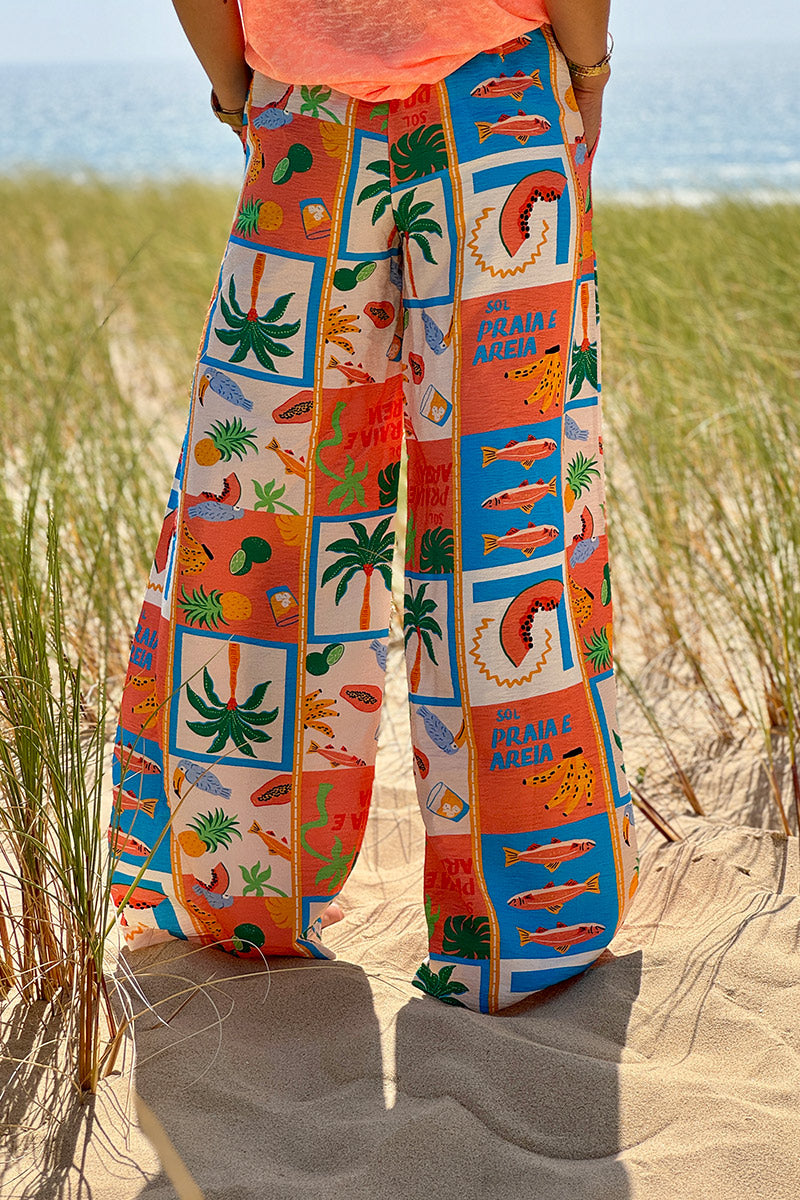 Pantalon fluide imprimé vacances d'été pastèques ananas et palmiers colorés