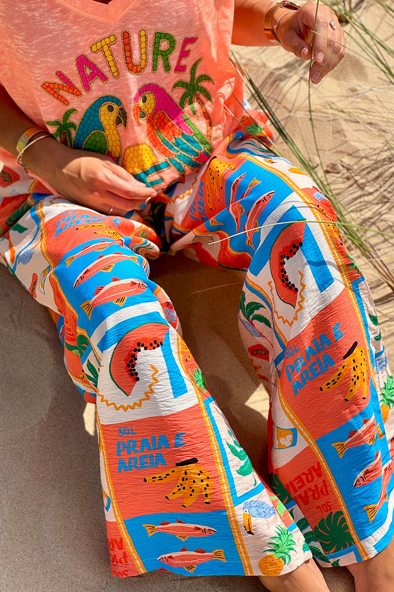 Pantalon fluide imprimé vacances d'été pastèques ananas et palmiers colorés