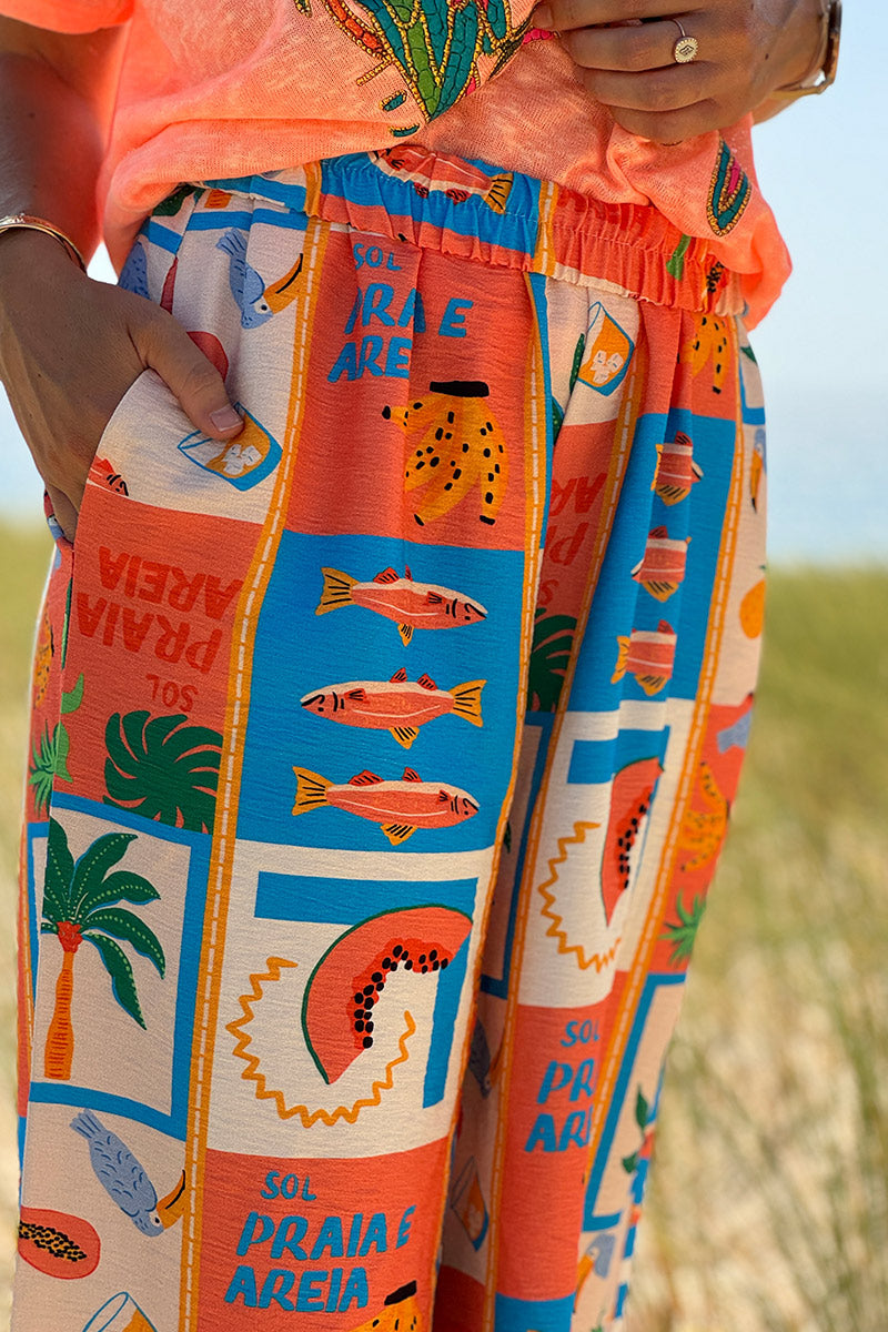 Pantalon fluide imprimé vacances d'été pastèques ananas et palmiers colorés
