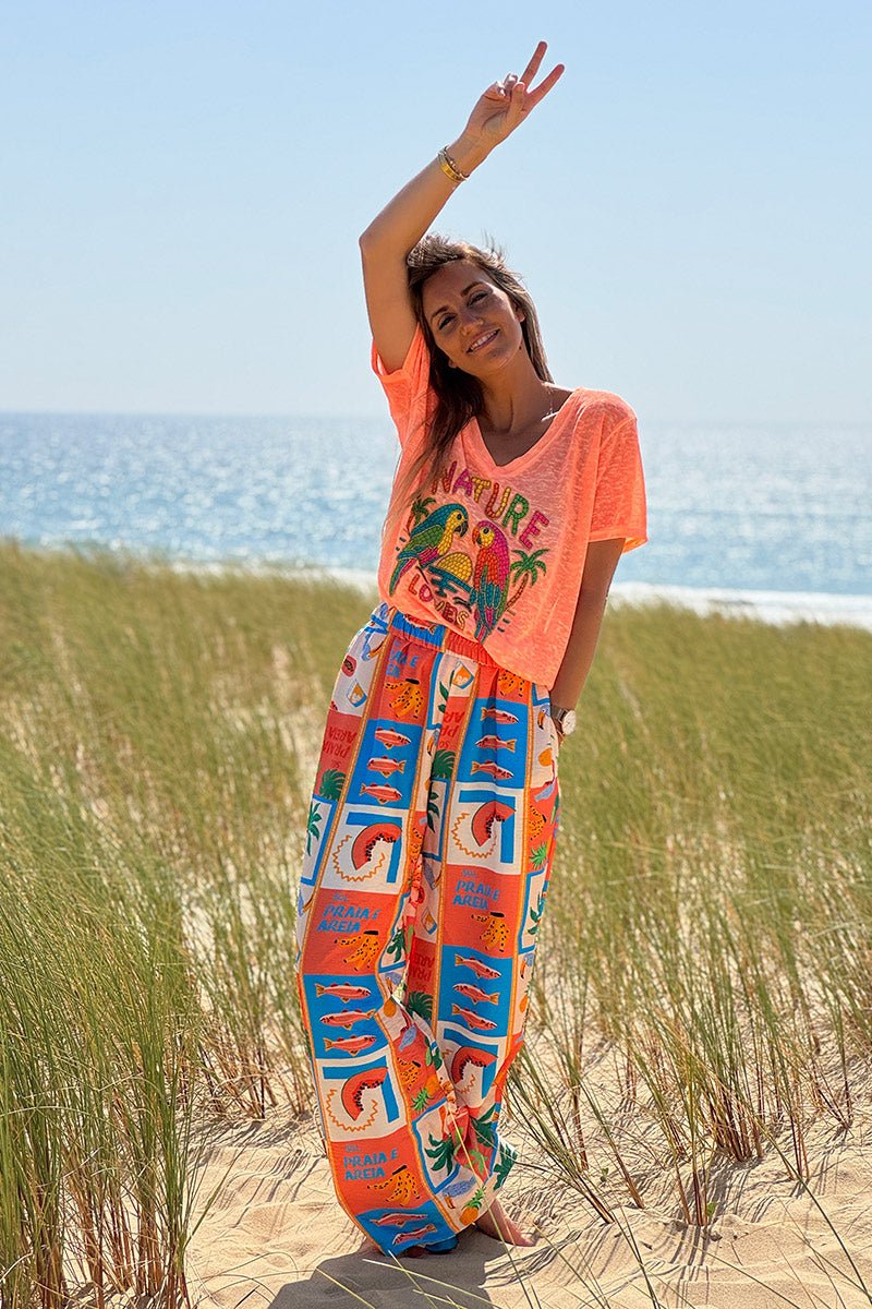 Pantalon fluide imprimé vacances d'été pastèques ananas et palmiers colorés