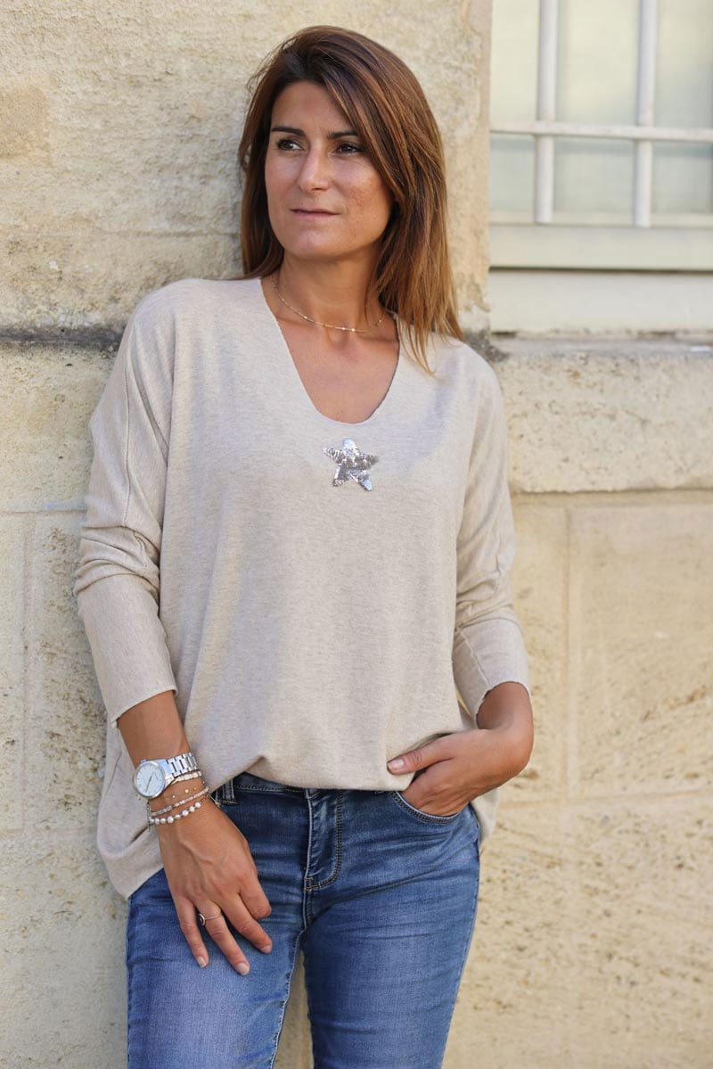 Beige v neck sweater with small sequin star