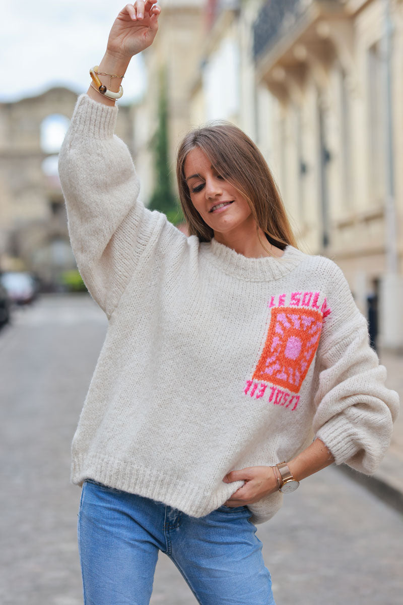 Beige chunky knit sweater with vibrant sun embroidery
