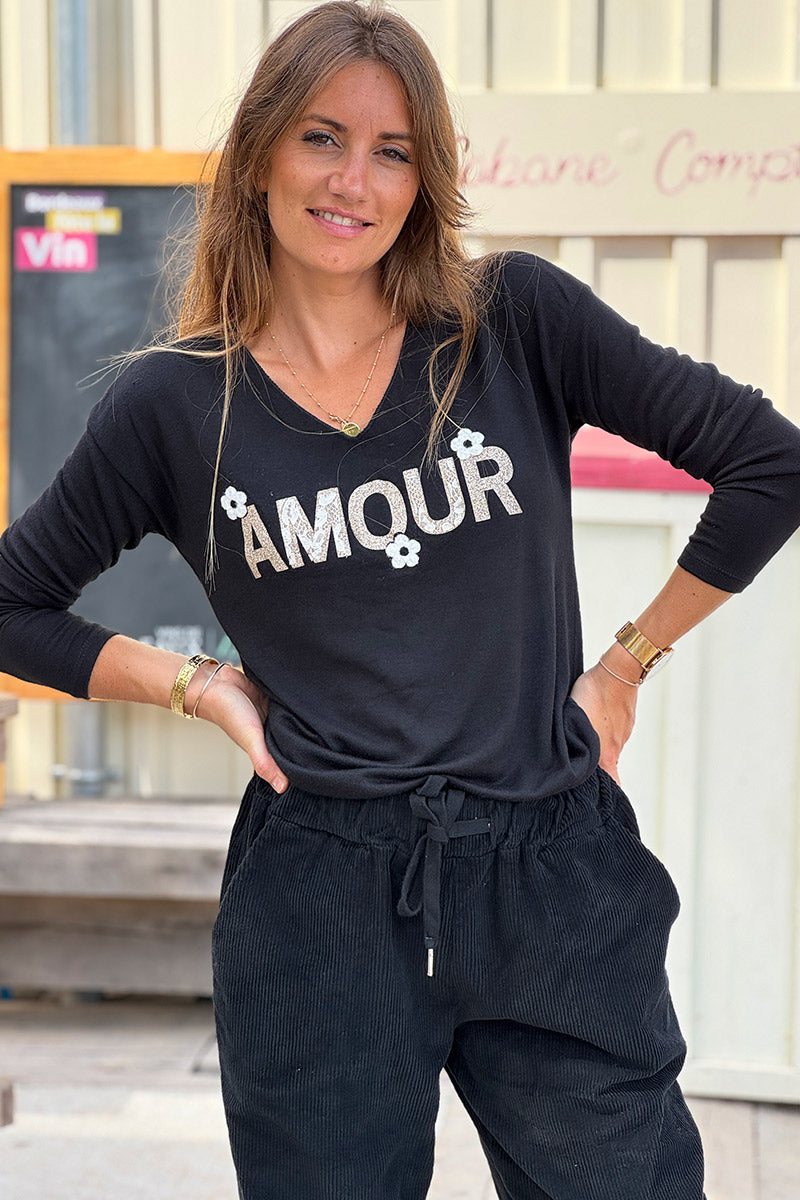Pull noir en jersey doux Amour en paillettes dorées et fleurs bouclettes