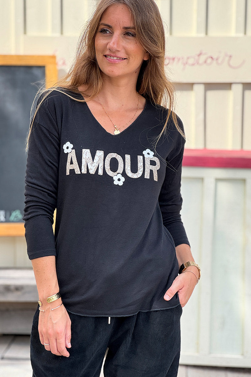 Pull noir en jersey doux Amour en paillettes dorées et fleurs bouclettes
