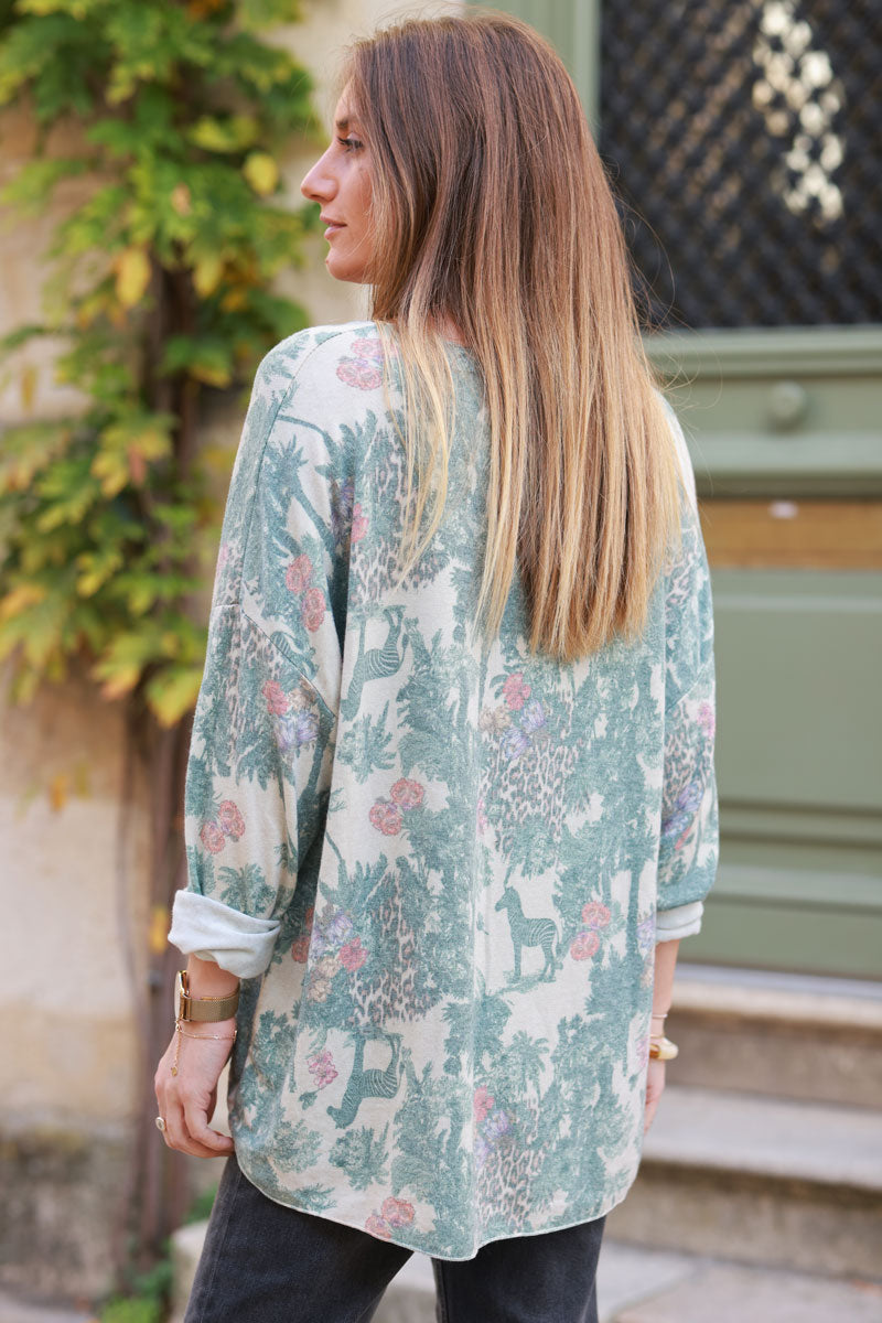 Soft Celadon green v-neck jumper with jungle-inspired toile de Jouy print
