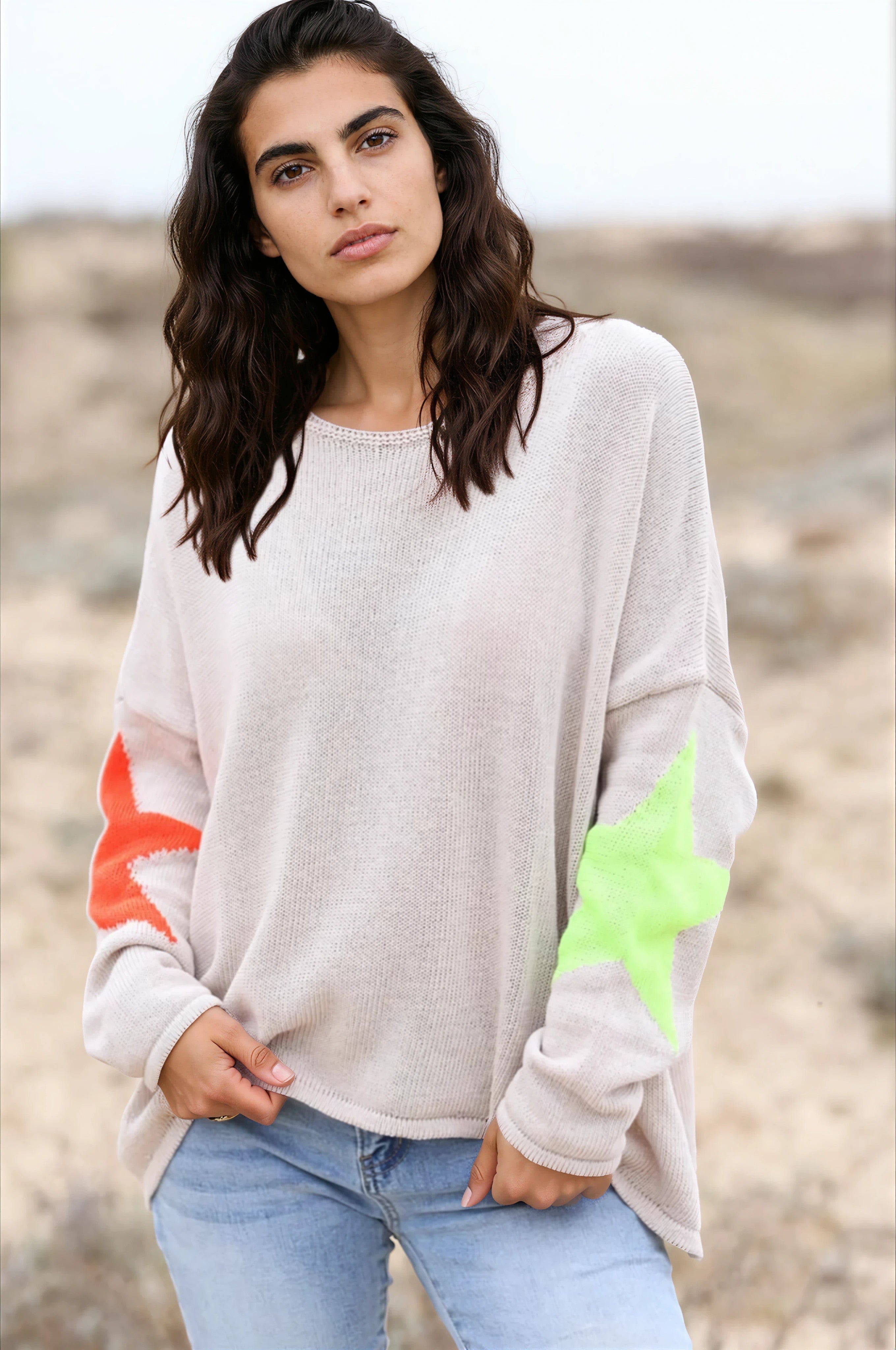 Beige knit sweater with colourful stars