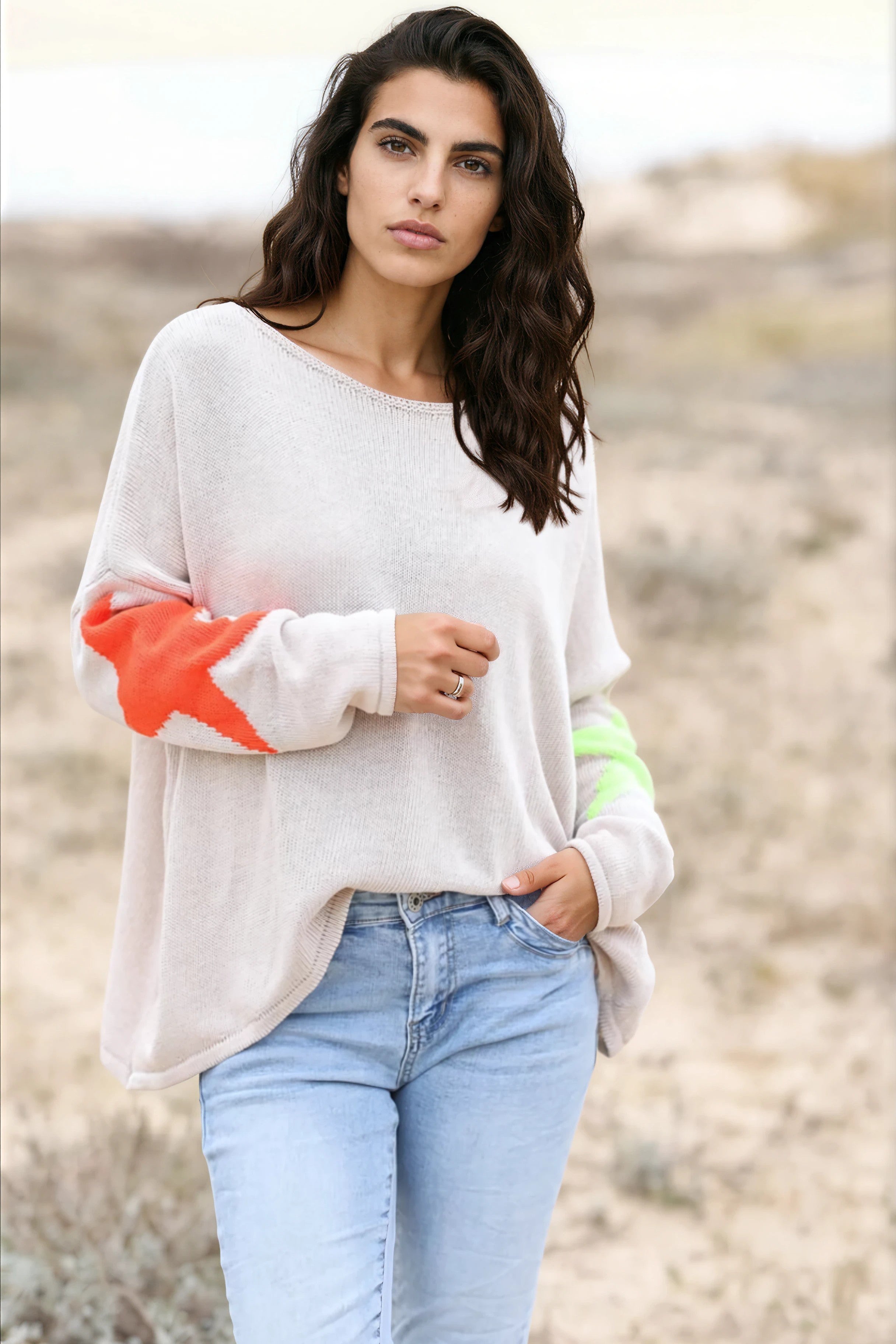 Beige knit sweater with colourful stars