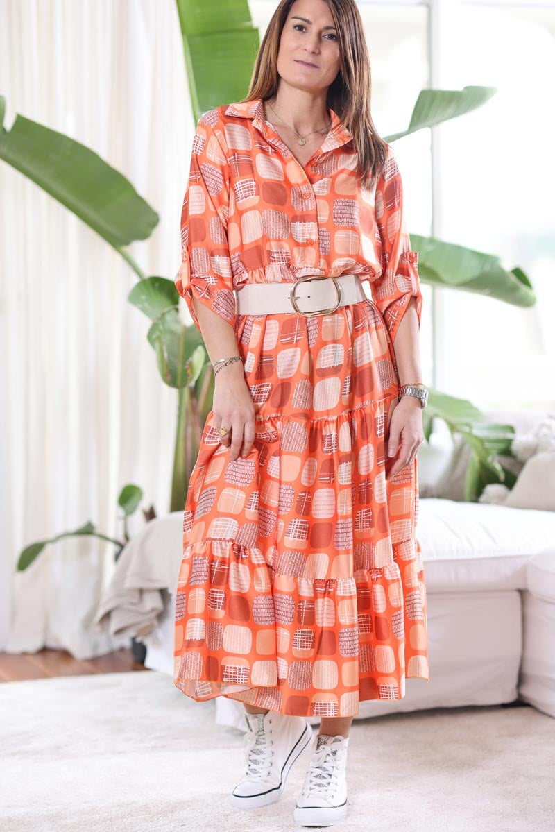 Midi flowing orange dress with 70s inspired geometric print