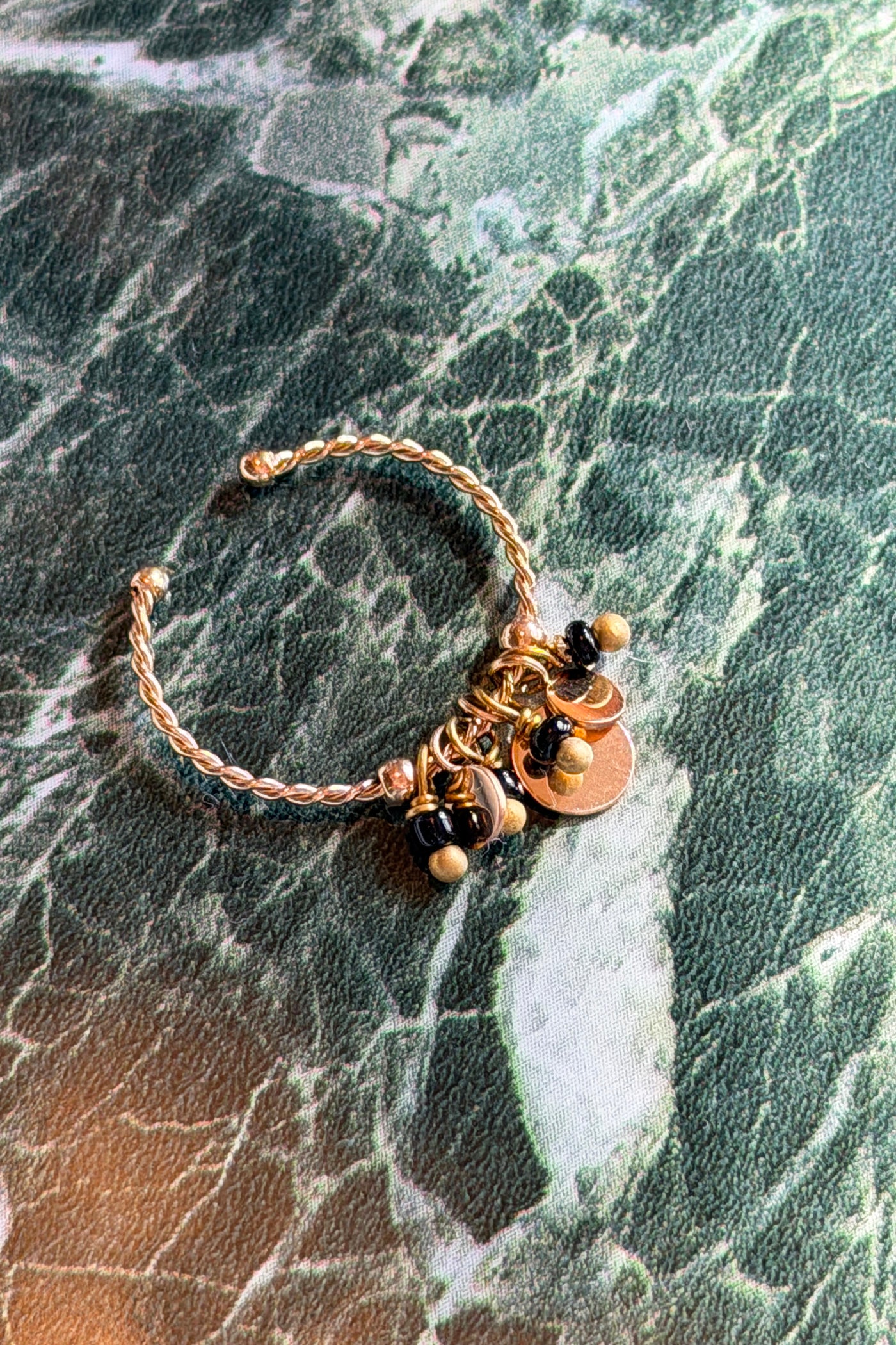 Adjustable gold braided ring with small black charms