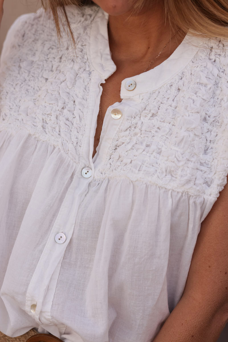 White floaty cotton sleeveless blouse with mother of pearl buttons