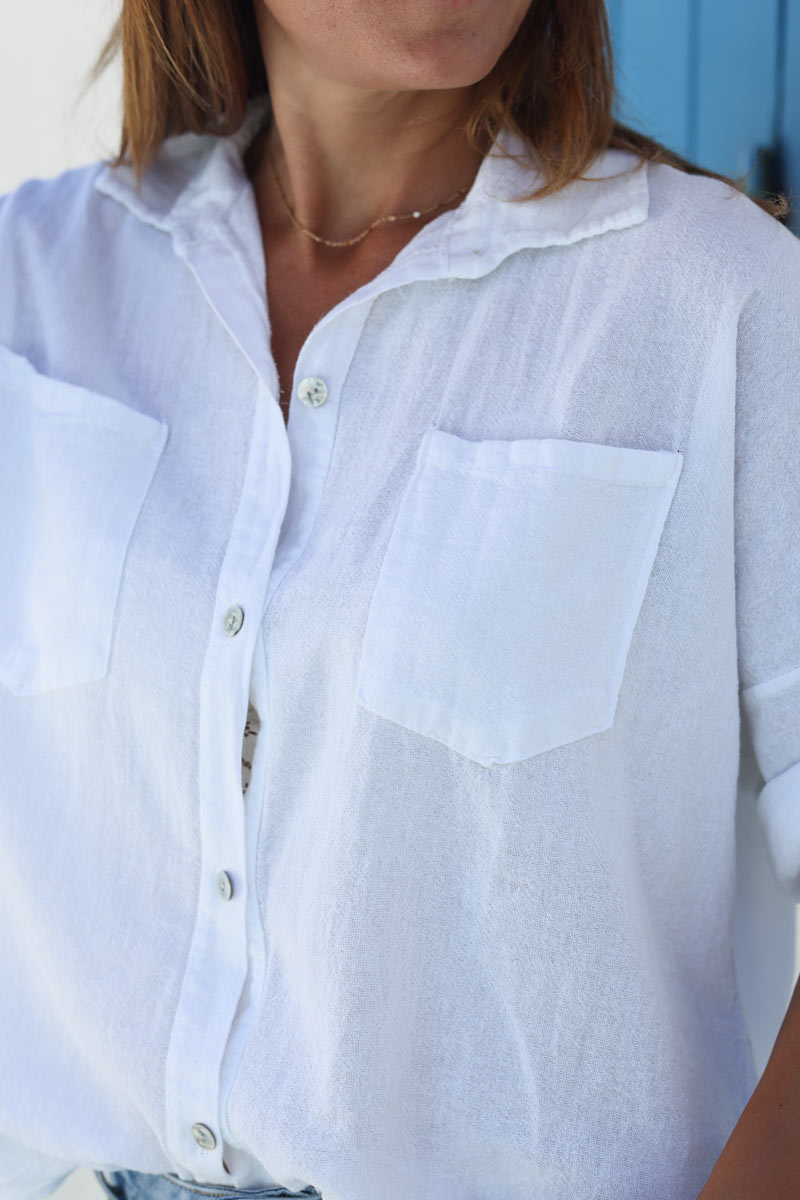 Camisa de algodón blanca suave con mangas 3/4 y bolsillos grandes.