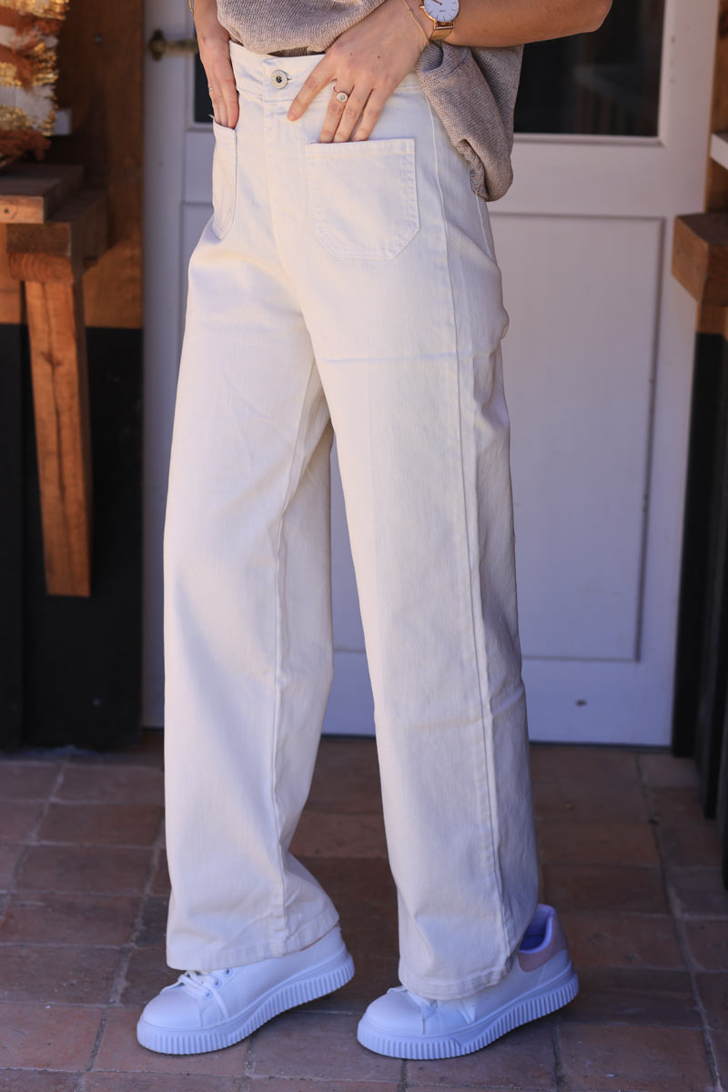 Off-white bootcut jeans with a wide leg cut and patch pockets