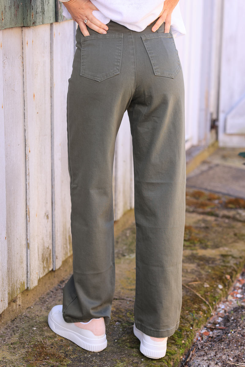 Khaki bootcut jeans with a wide leg cut and patch pockets