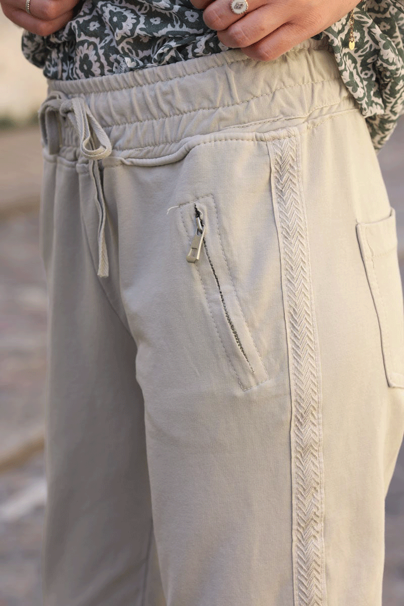 Beige cotton sweatpants bottoms with embroidered cheveron outseams