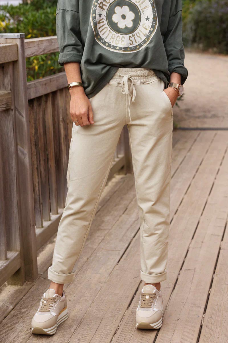 Beige stretch sweatpants with ribbon outseam zipped pockets