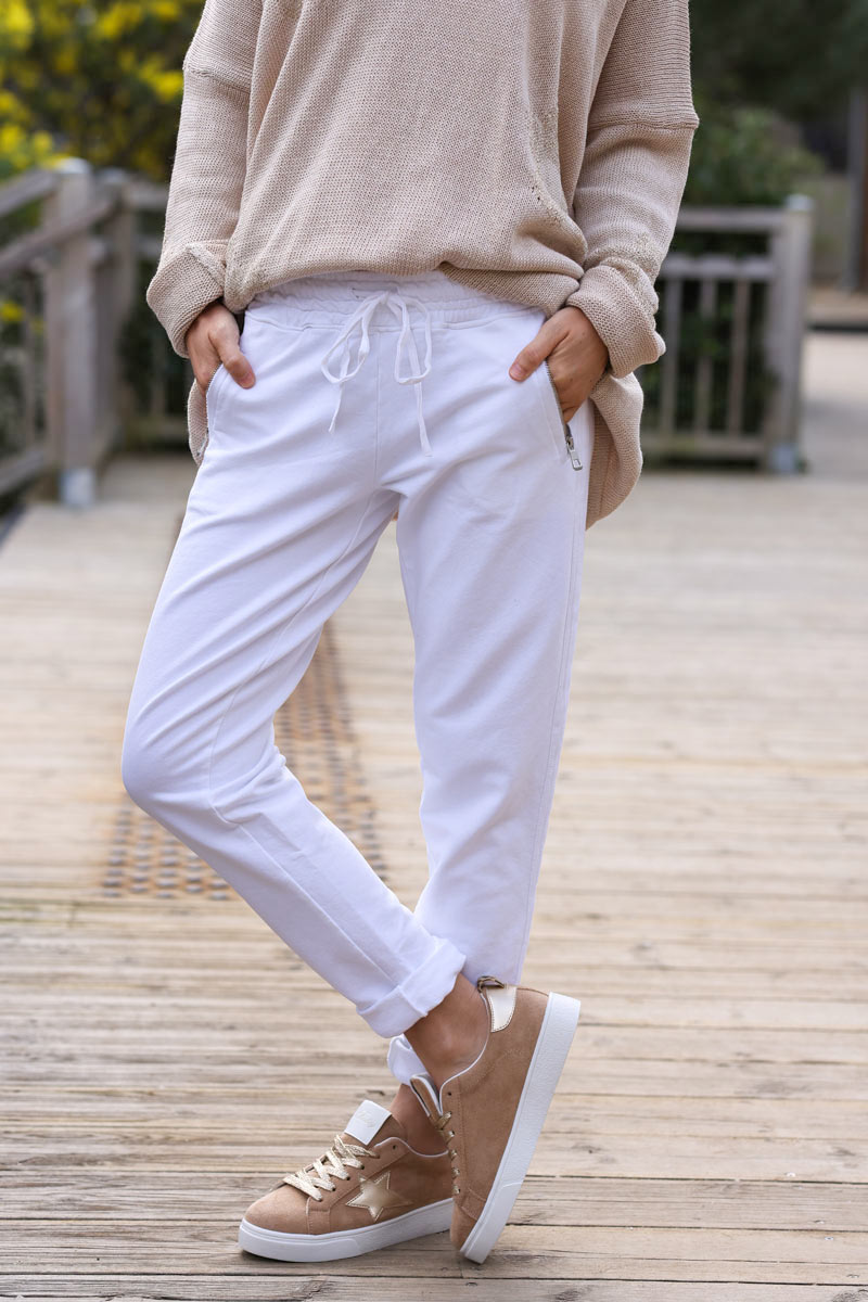 White stretch sweatpants with ribbon outseam zipped pockets