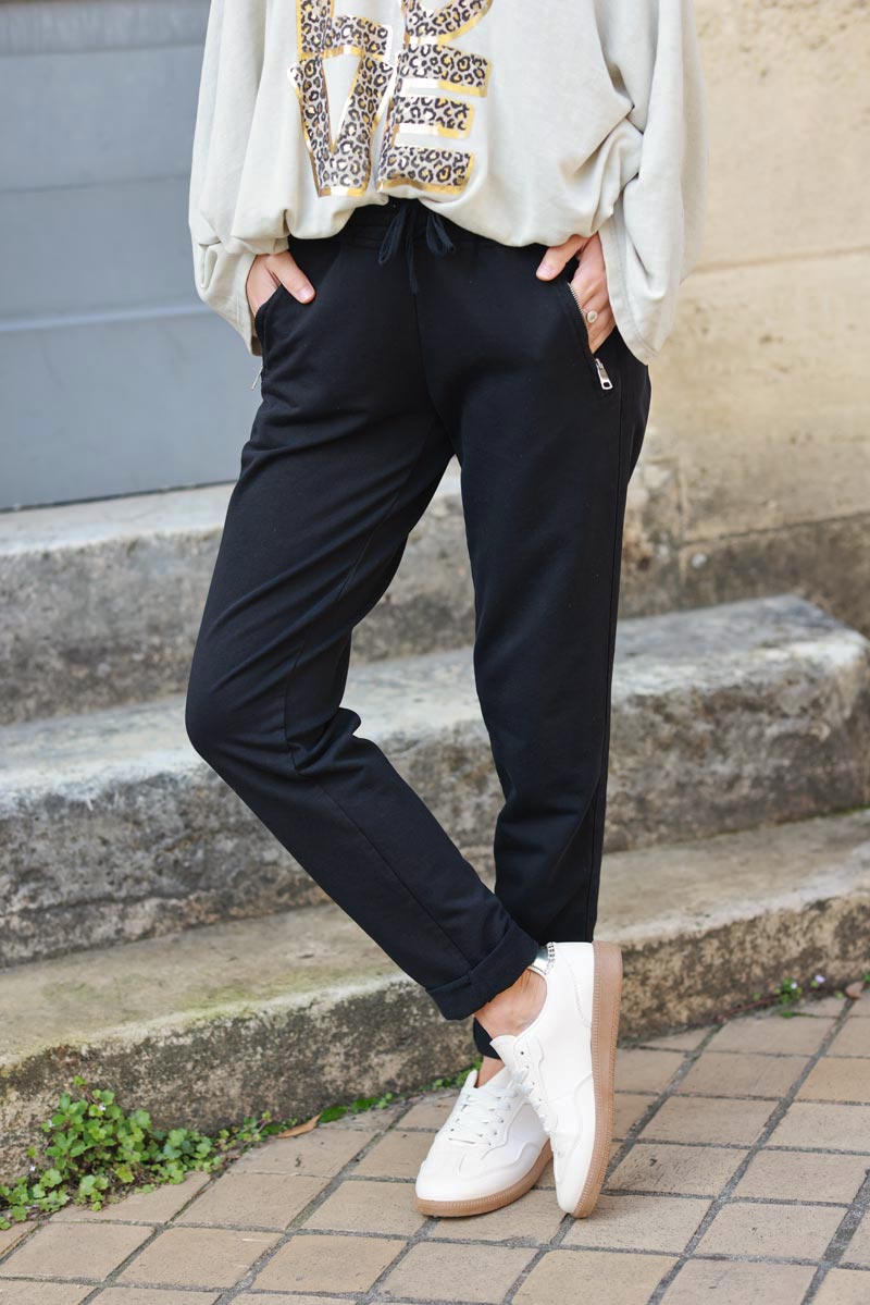 Black stretch sweatpants with ribbon outseam zipped pockets