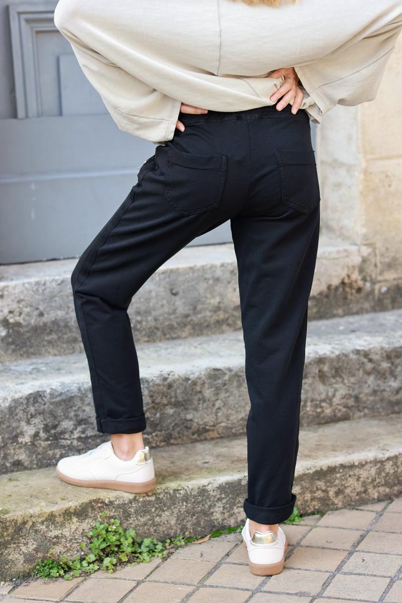 Black stretch sweatpants with ribbon outseam zipped pockets