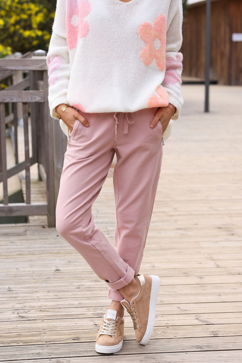 Pantalón jogging rosa viejo con ribete de cinta en los laterales, bolsillos con cremallera, cinturilla elástica