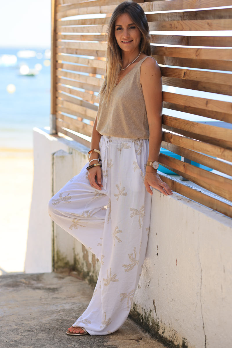 Off white floaty wide leg pants with beige palm tree print