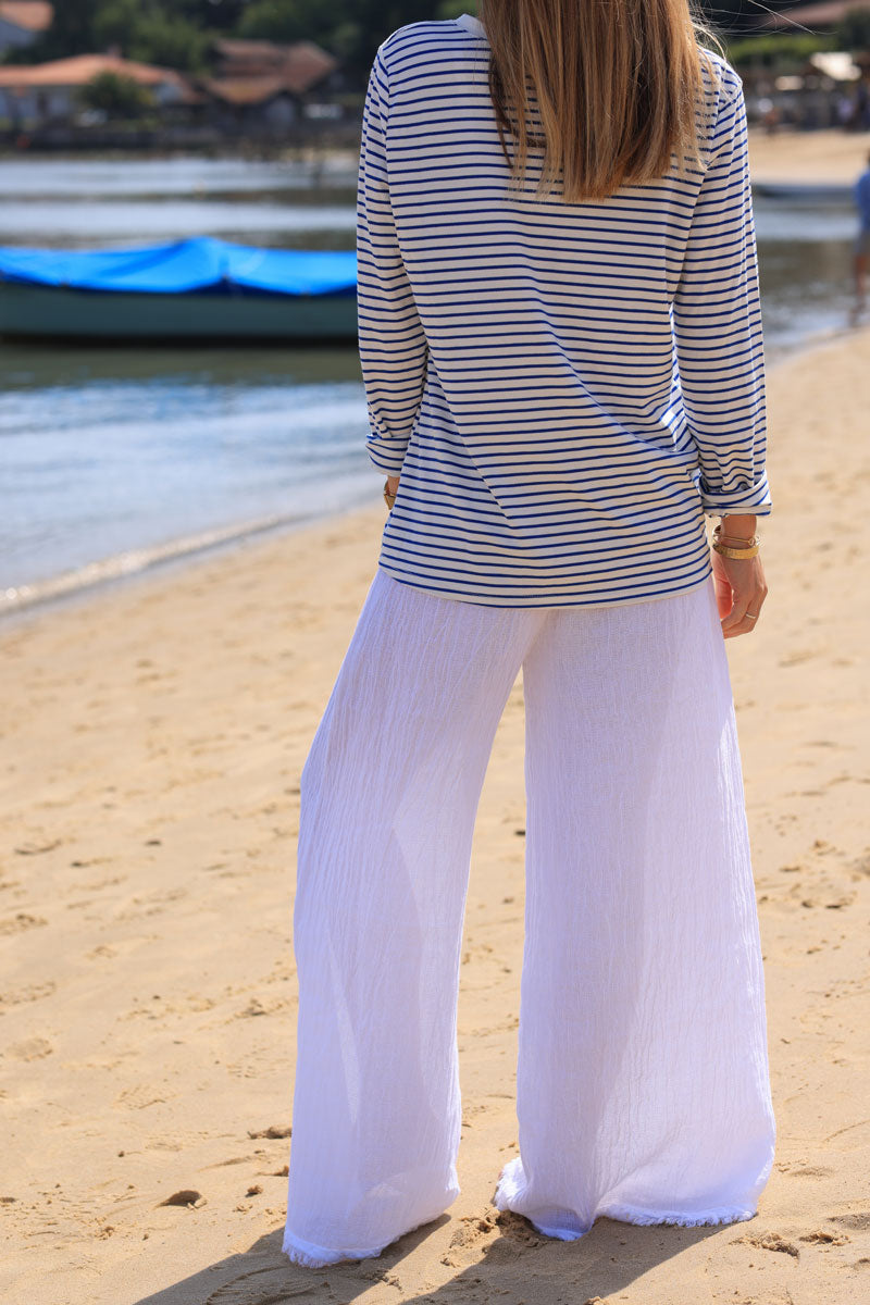 Wide leg white cotton and linen trousers with fringed hems