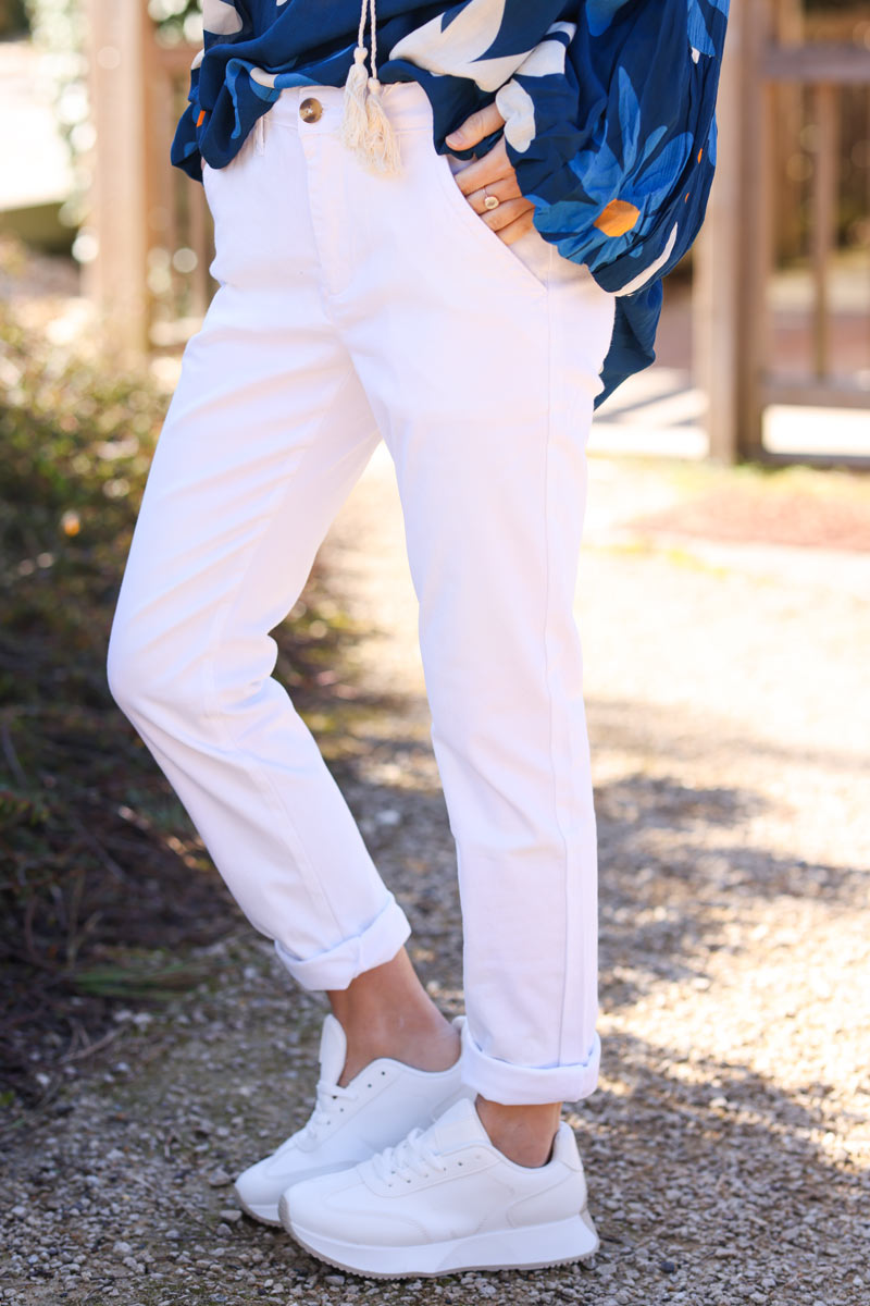 White stretch chino pants with tortoise shell buttons