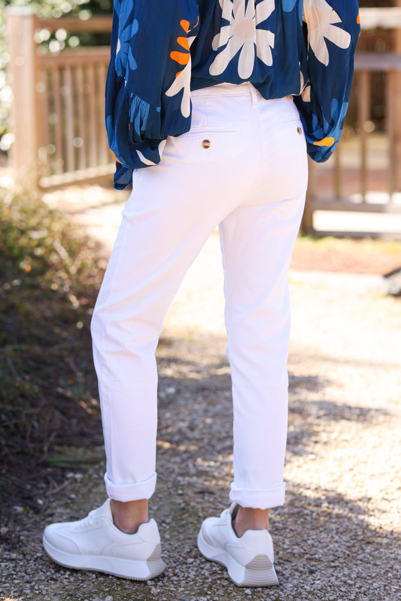 White stretch chino pants with tortoise shell buttons