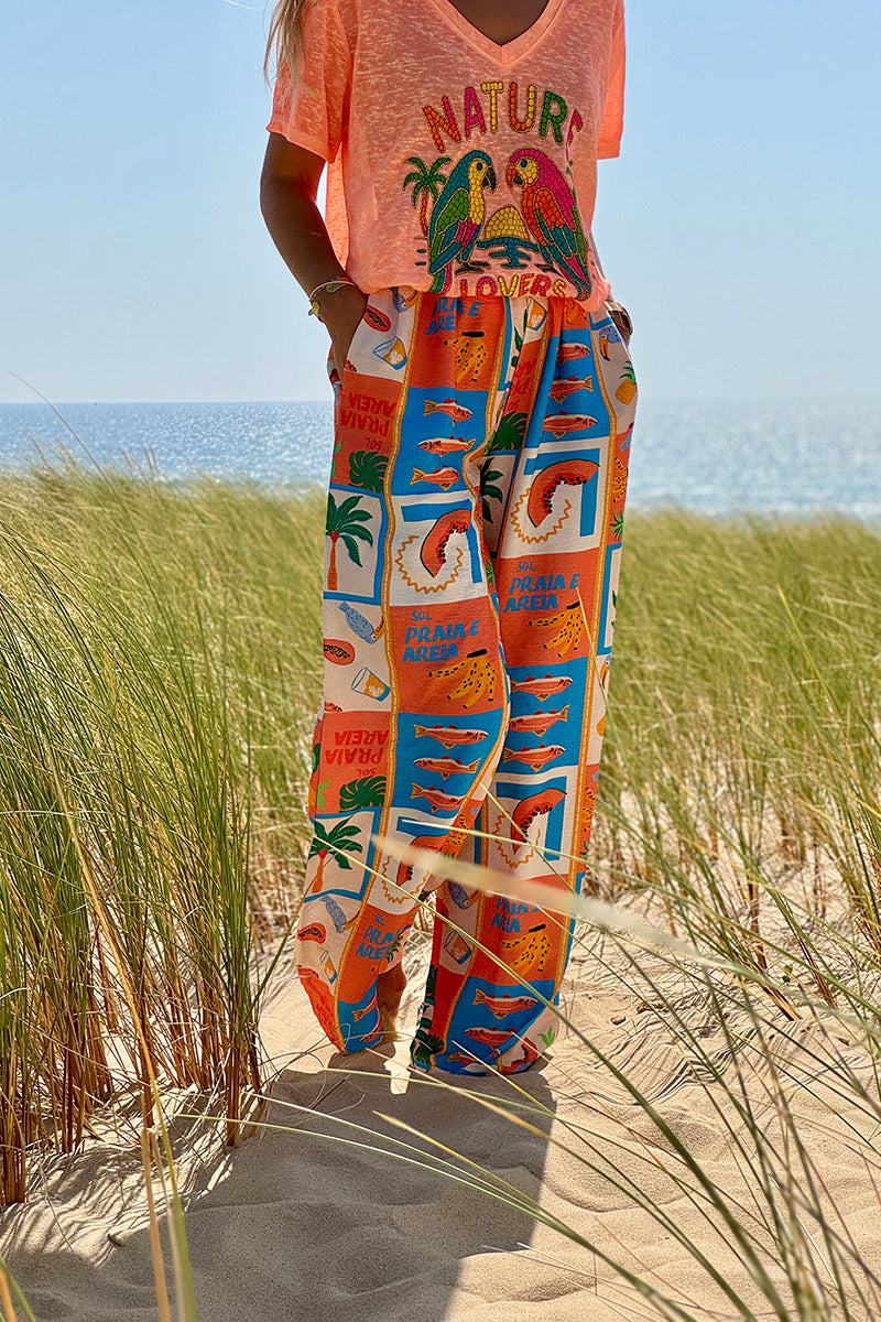 Pantalon fluide imprimé vacances d'été pastèques ananas et palmiers colorés