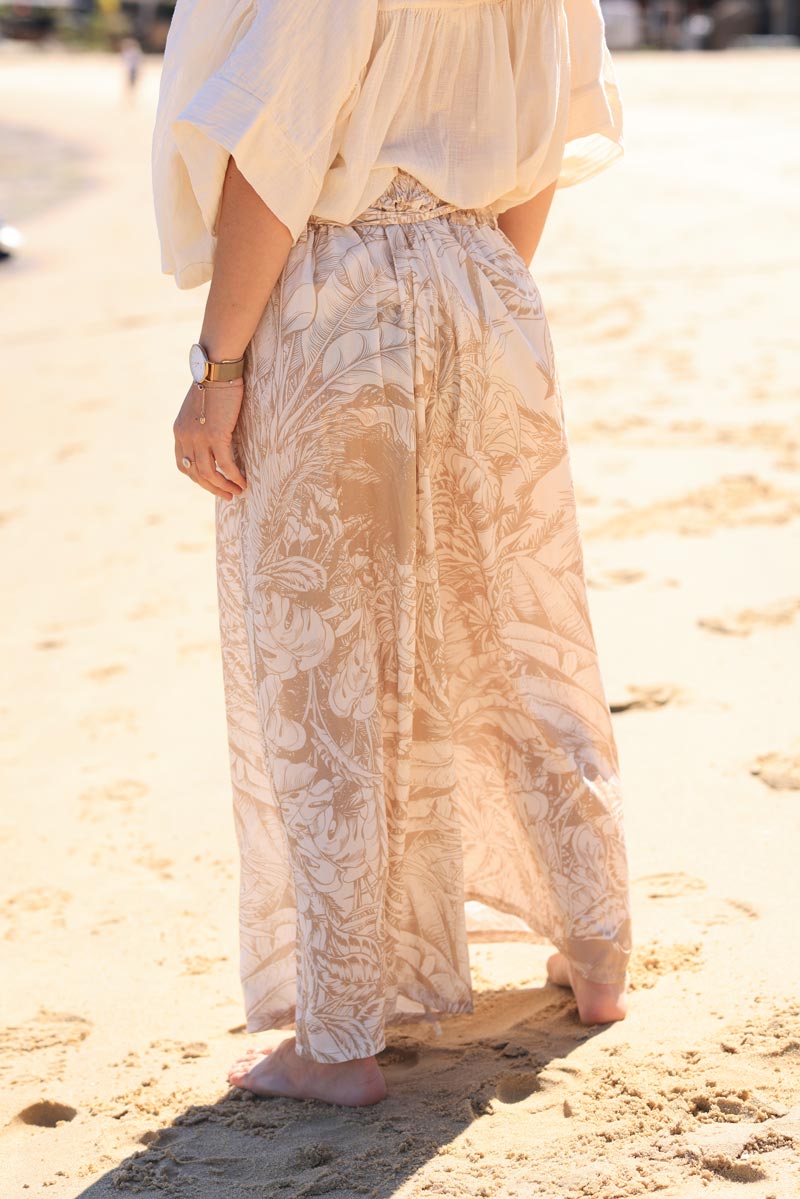 Beige wide leg floaty pants with palm leaf print and fabric belt