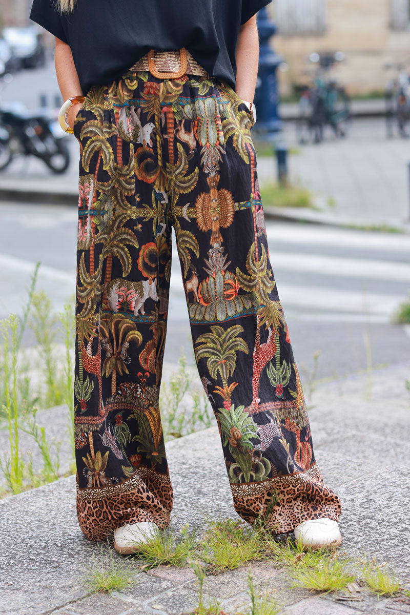 Black wide leg pants with jungle and leopard print, including belt