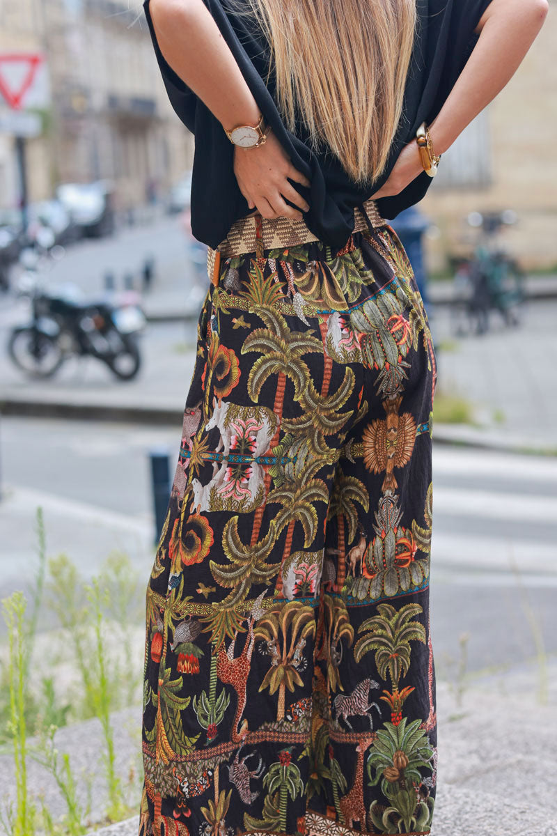 Black wide leg pants with jungle and leopard print, including belt