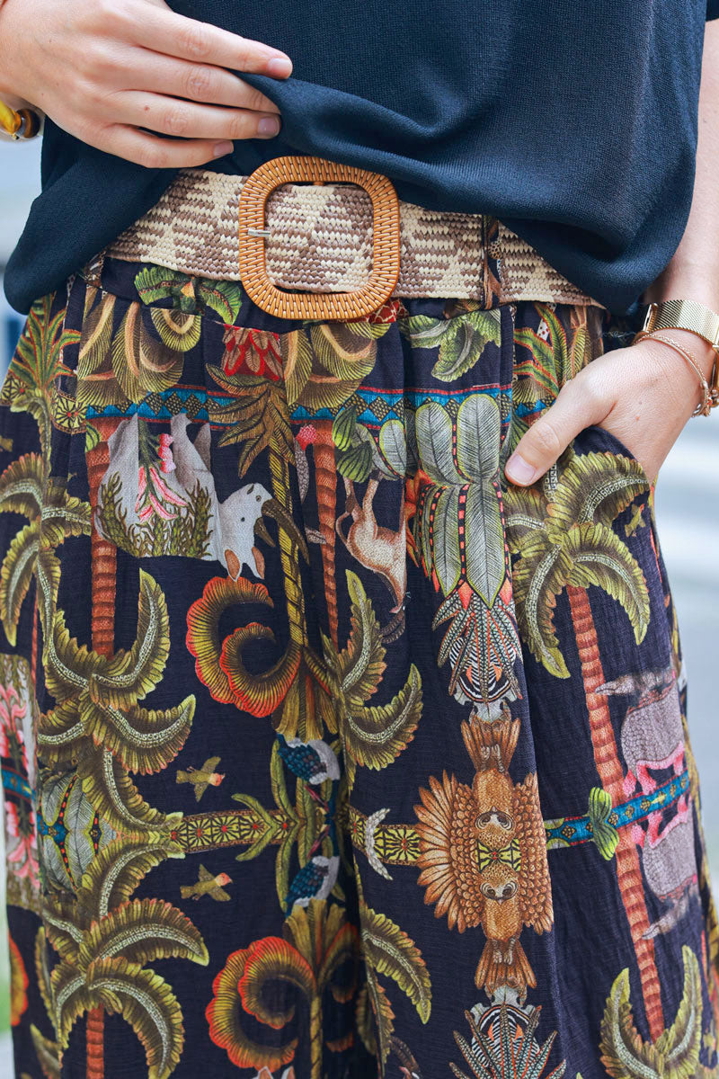 Black wide leg pants with jungle and leopard print, including belt