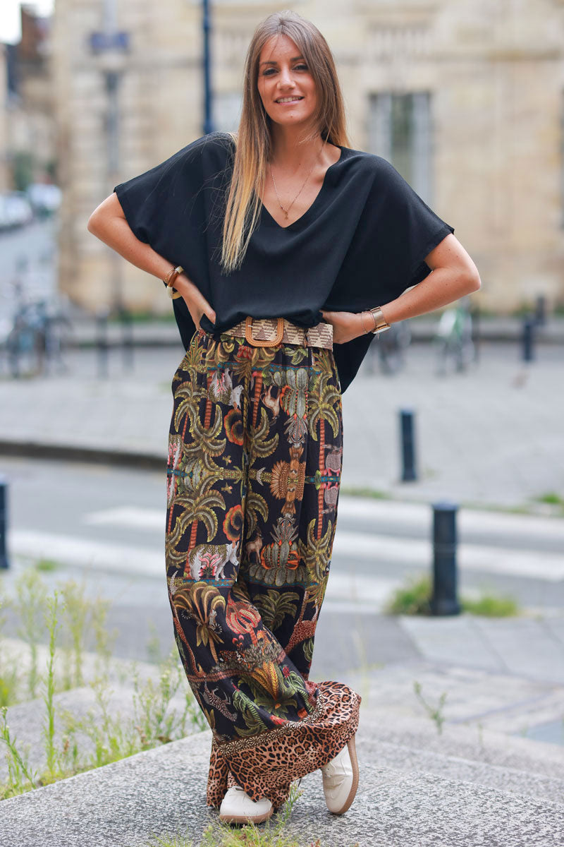 Black wide leg pants with jungle and leopard print, including belt